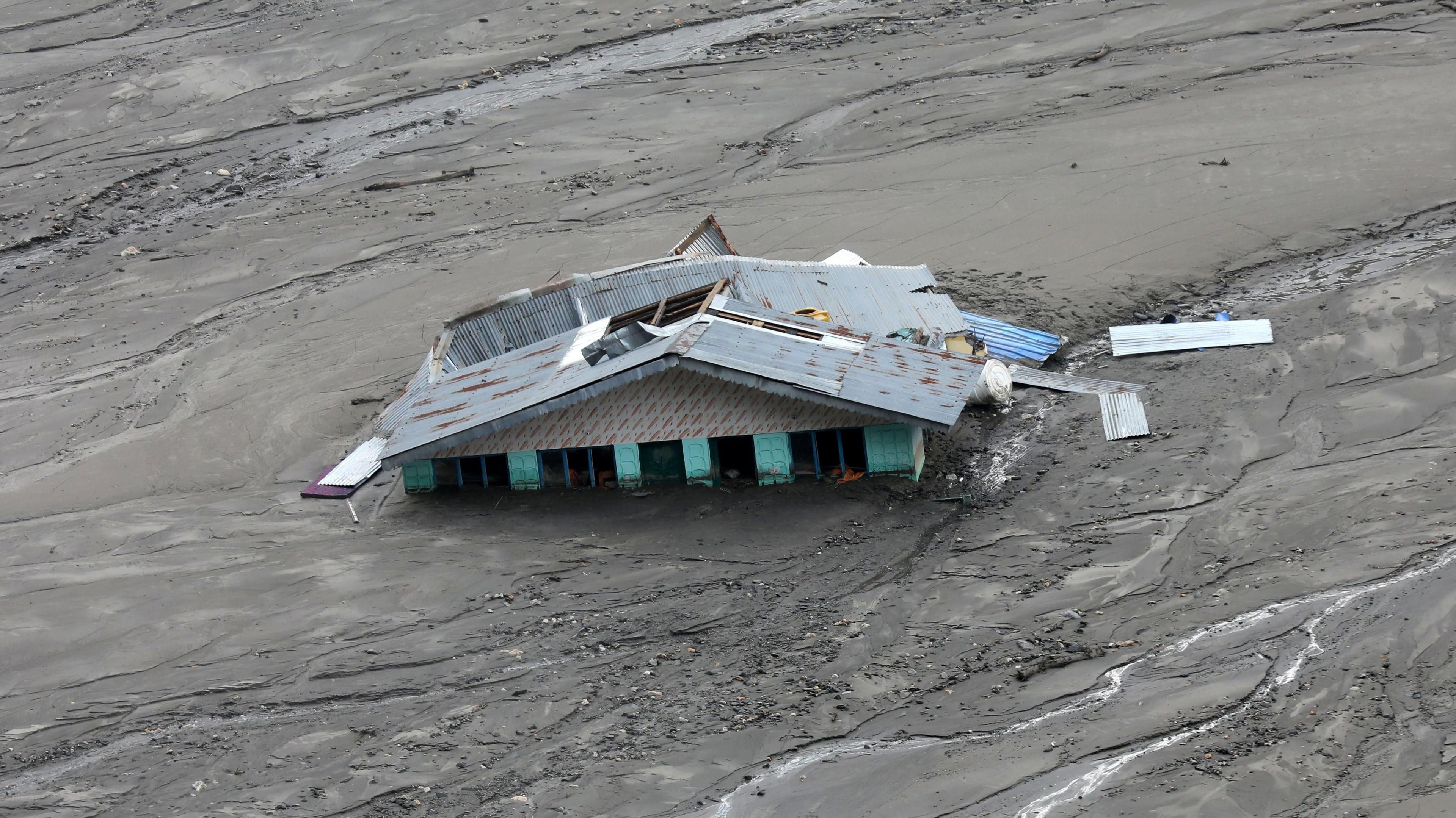 A mud-covered building after the cloudburst at Dharali village, Uttarakhand state, India on 11 August 2025.