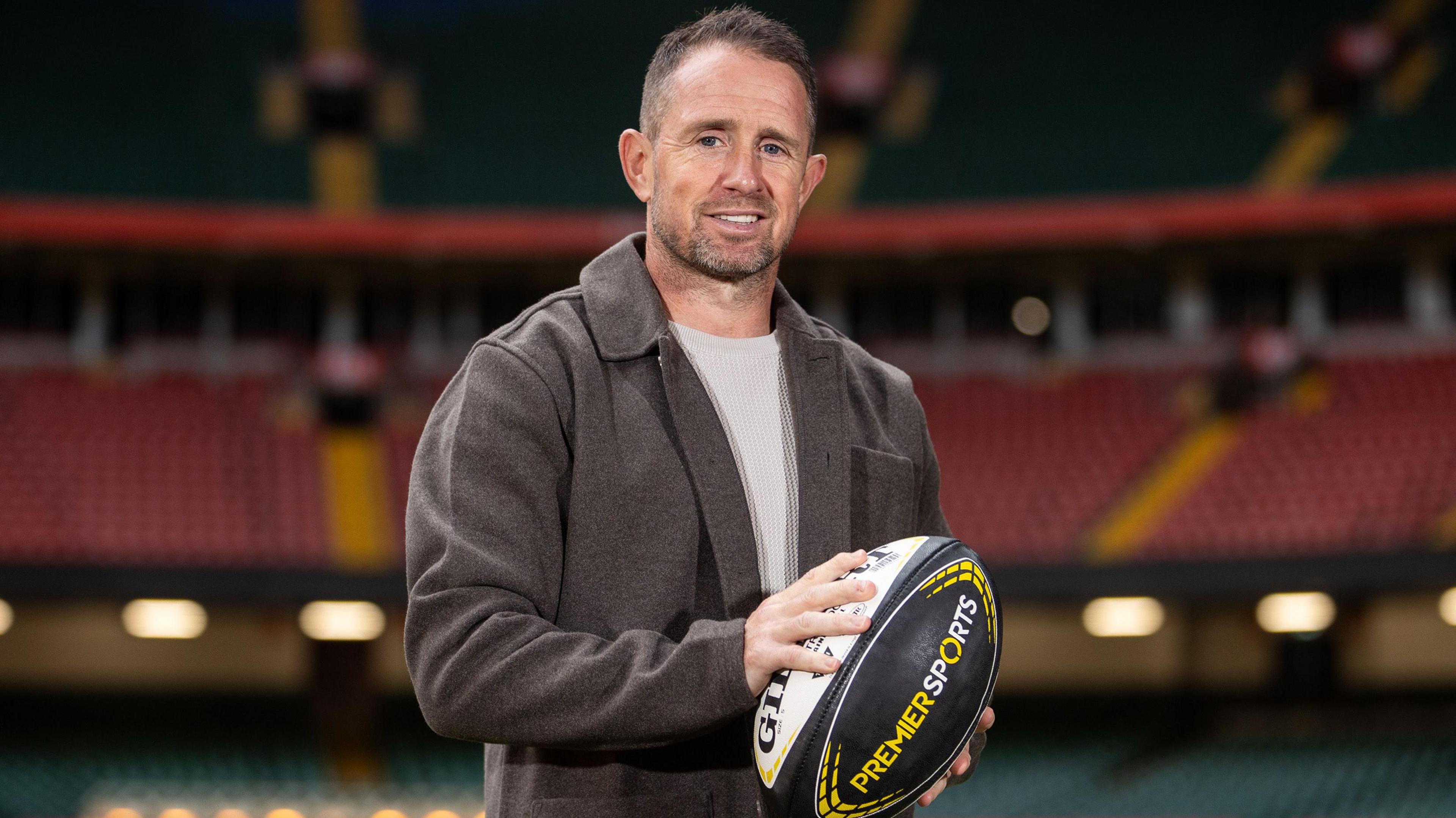 Shane Williams poses with a rugby ball at Principality Stadium