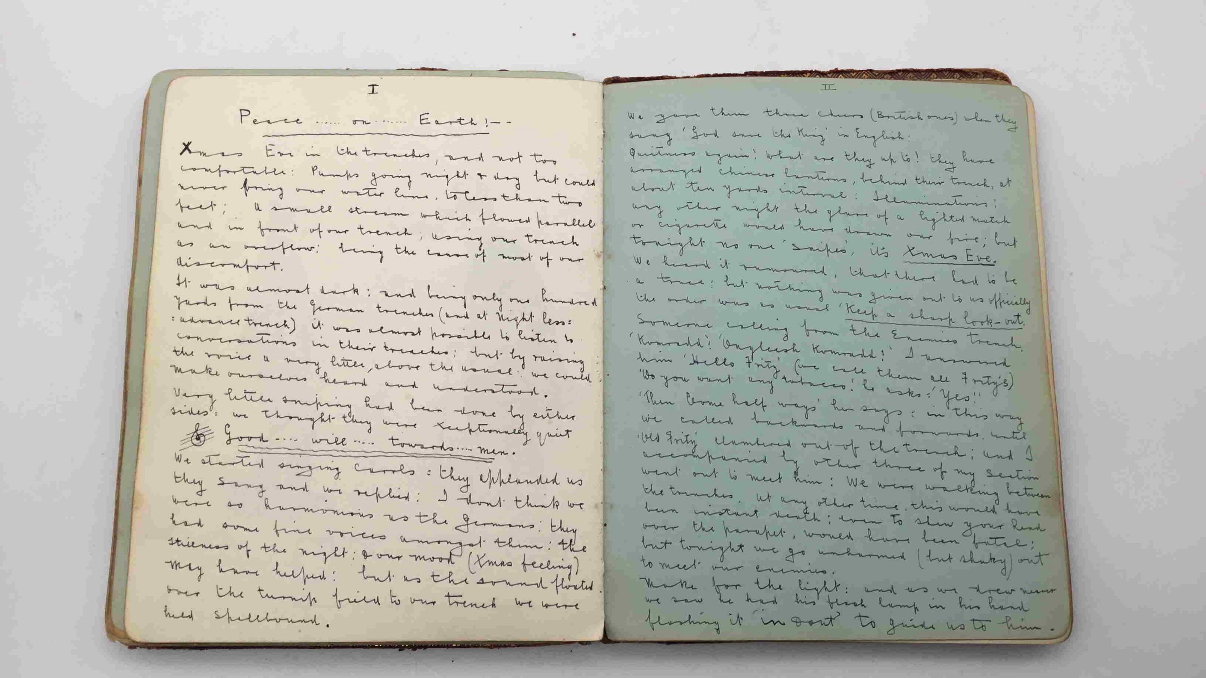 Old album opened to reveal two pages of neat handwriting describing the Christmas truce of 1914.