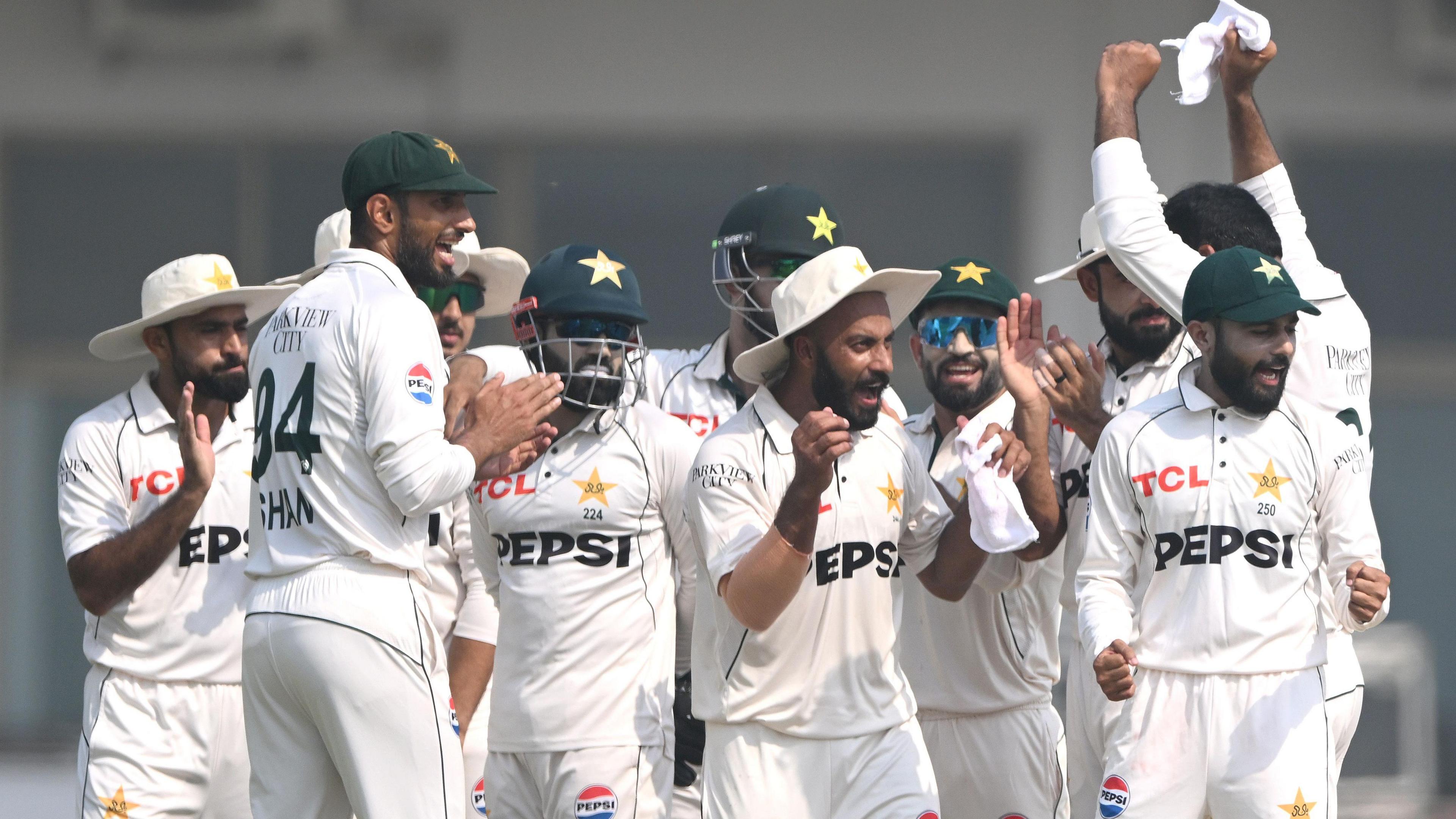 Pakistan players celebrate a wicket against England during the second Multan Test