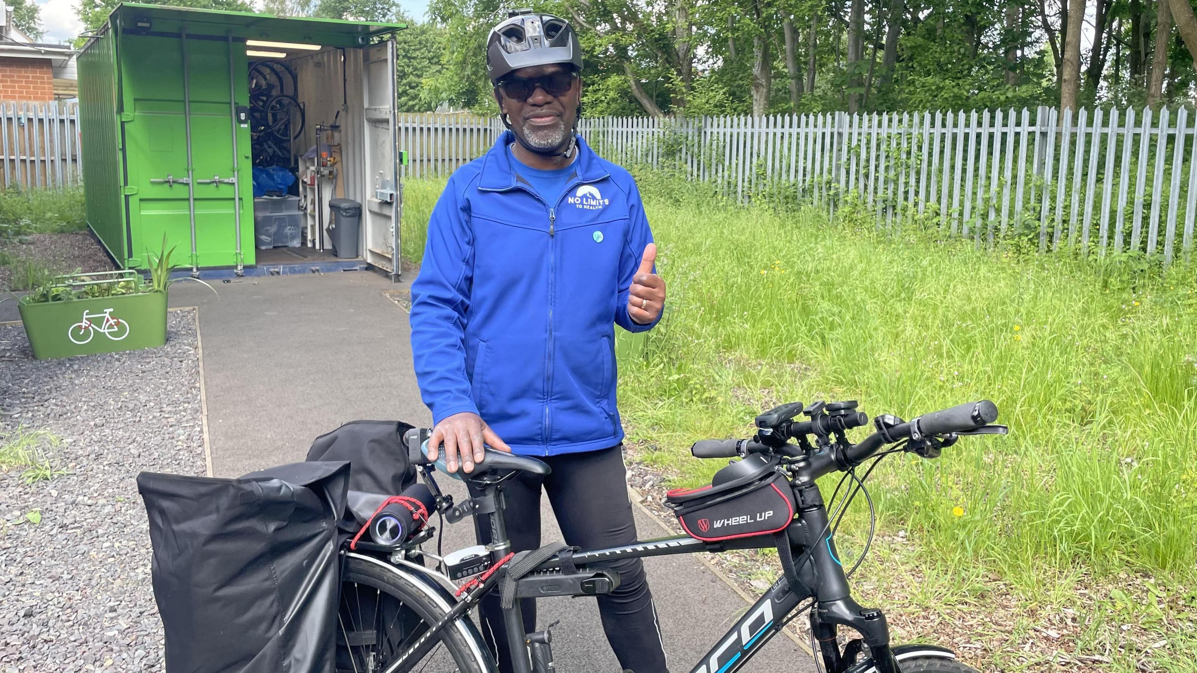 Sam Henry standing next to his bike