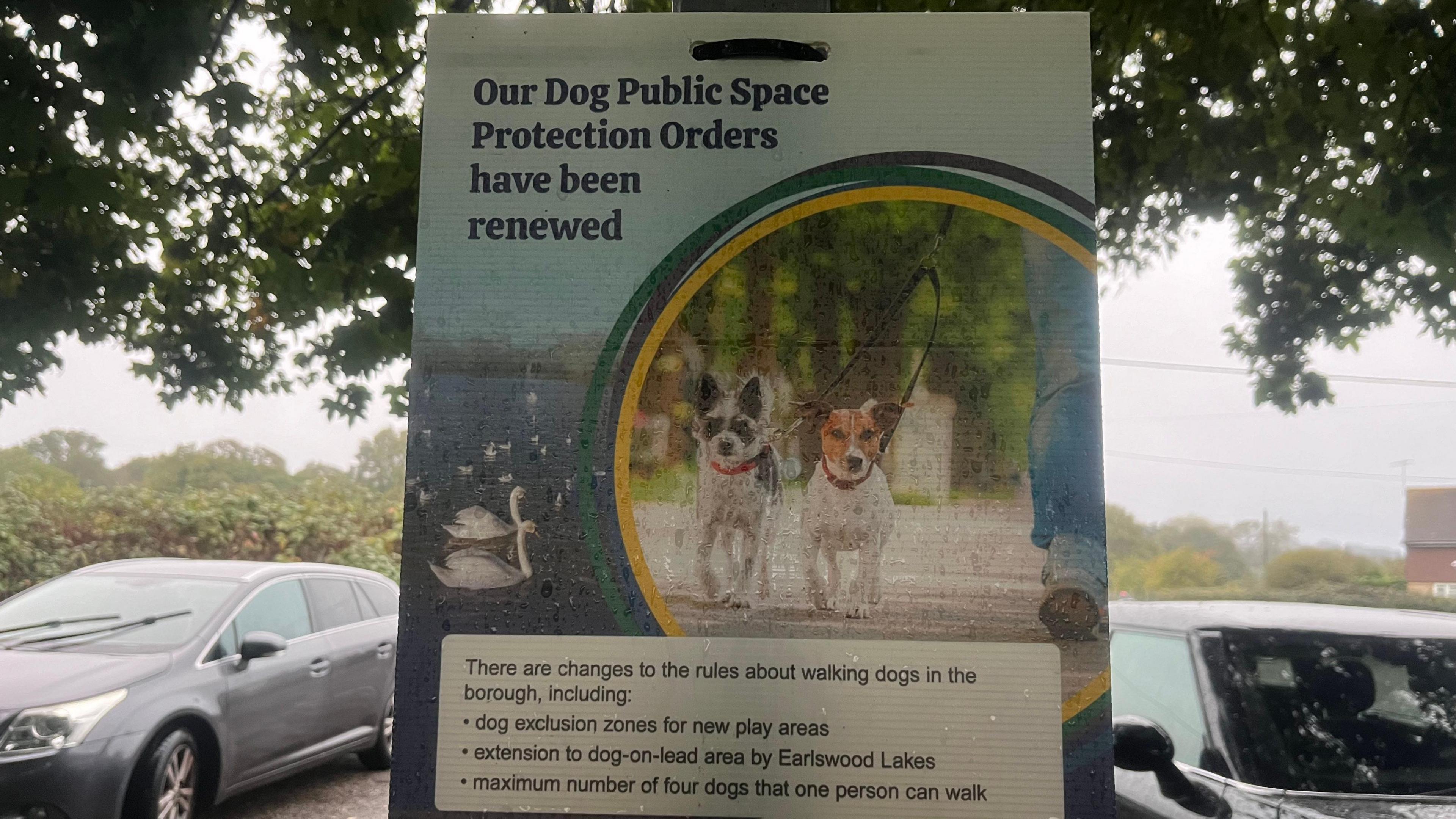 A sign which shows two dogs being walked on a lead and states that dog public space protection orders have been renewed along with listing the changes which include the change to limits as well as a dog exclusion zone in new play areas and an extension to a dog-on-lead area.