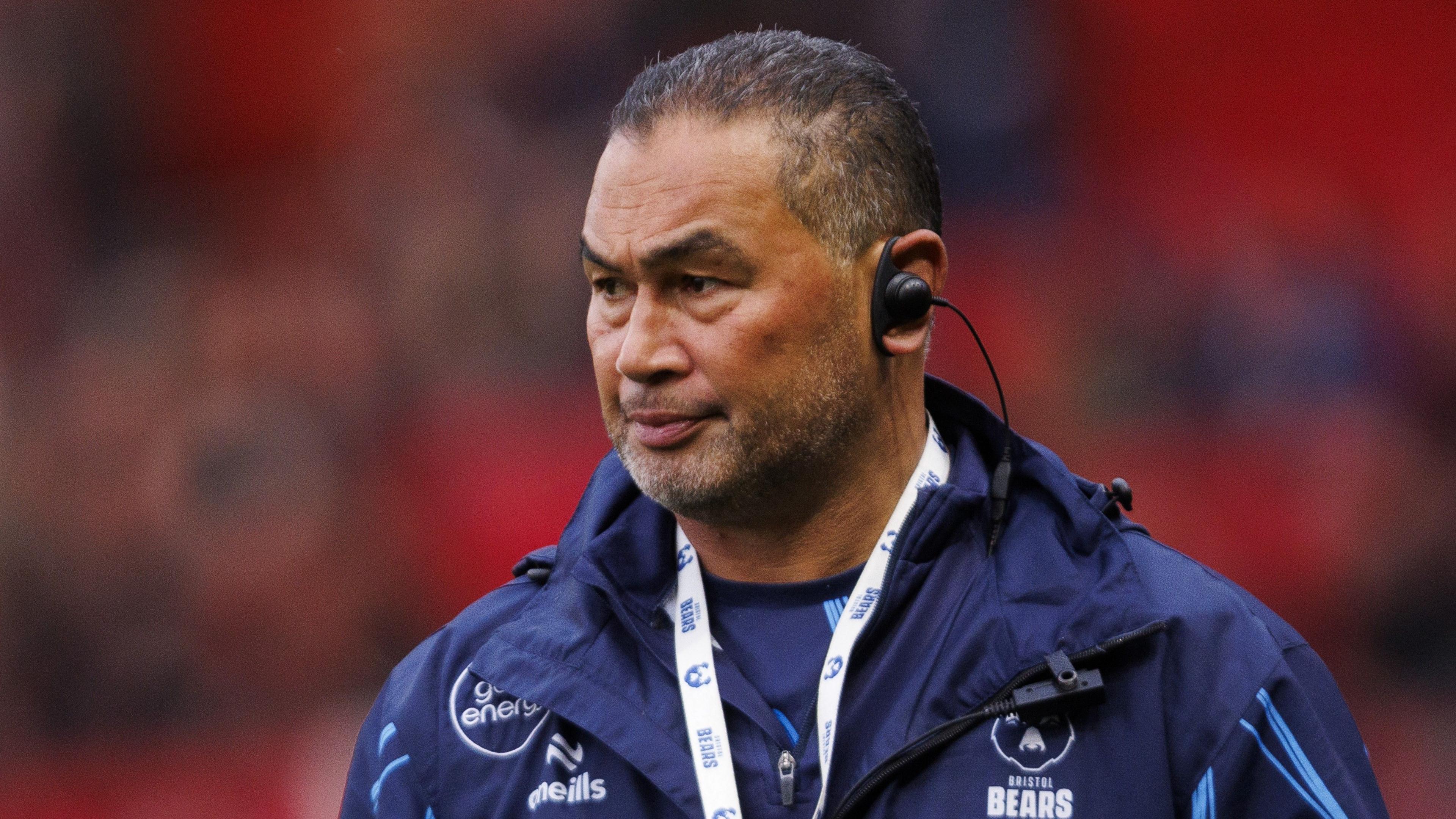 Bristol Bears director of rugby Pat Lam stands wearing a blue jacket and also has an ear piece in during a warm-up for a Prem Rugby match.