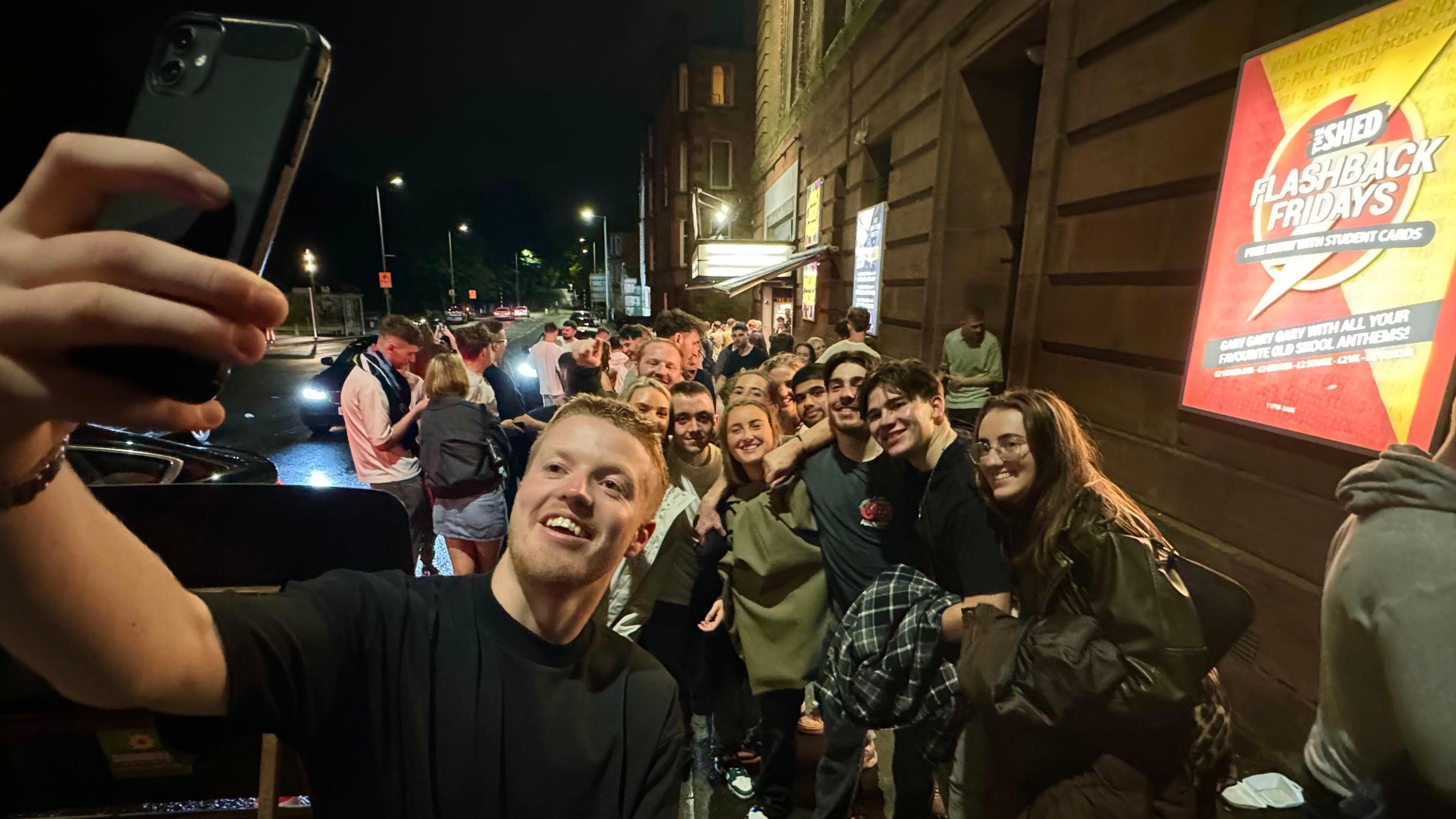 Clubber taking selfie of queue outside The Shed 