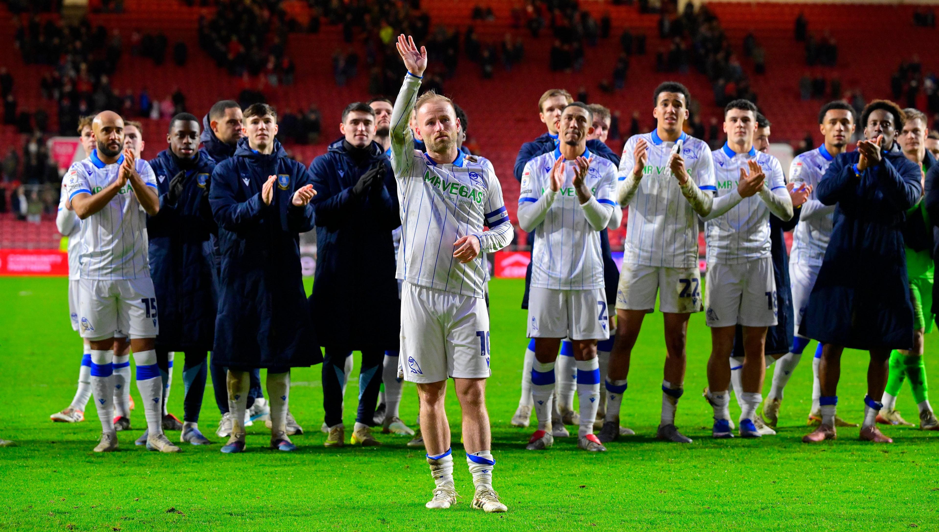 The Sheffield Wednesday squad applauds an emotional Barry Bannan as he waves goodbye to the travelling supporters after playing his final game for the club in a 2-0 defeat at Bristol City