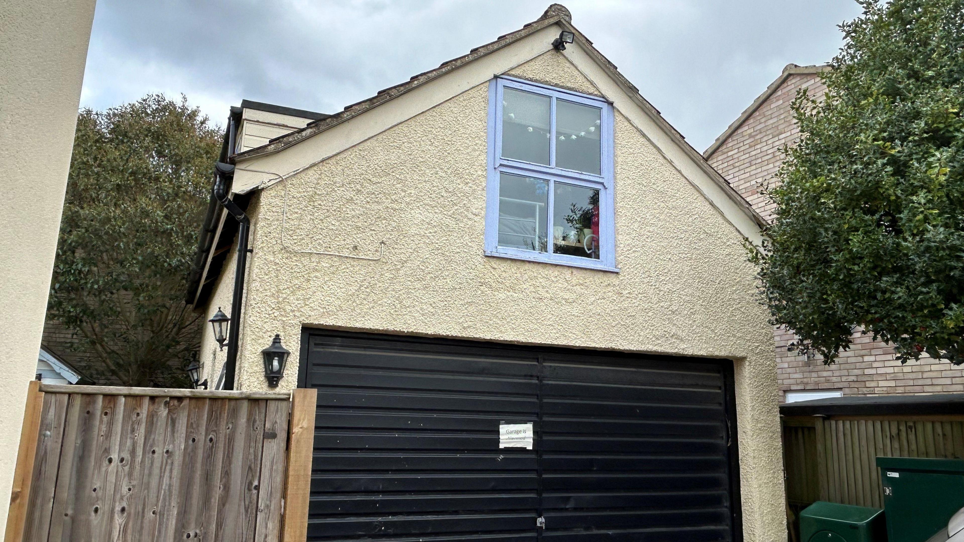 The outside of the part-converted garage