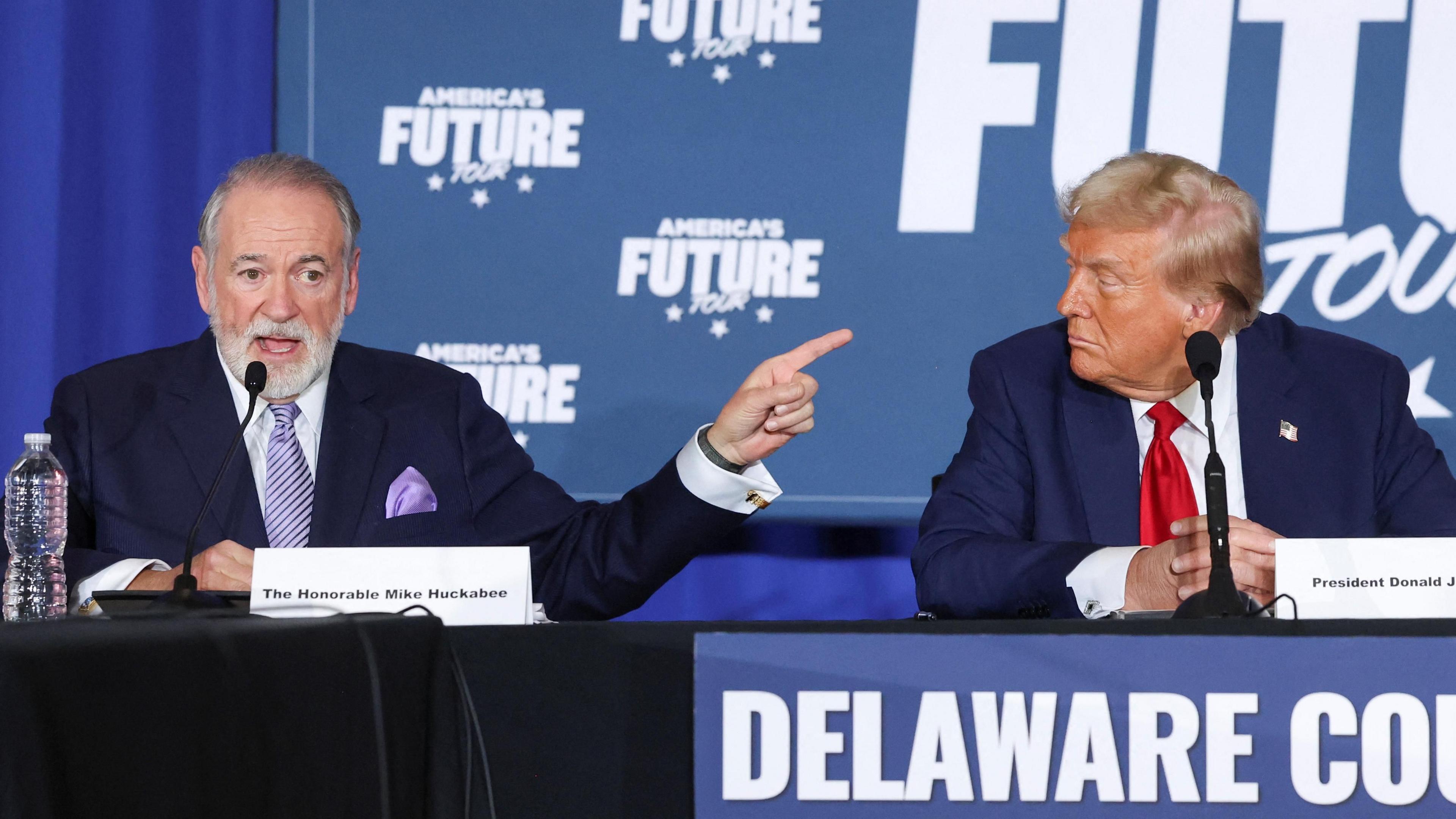 File photo showing Mike Huckabee (L) and Donald Trump (R) sitting in front of a sign saying America's Future Tour at a campaign event in Drexel Hill, Pennsylvania, US on 29 October 2024