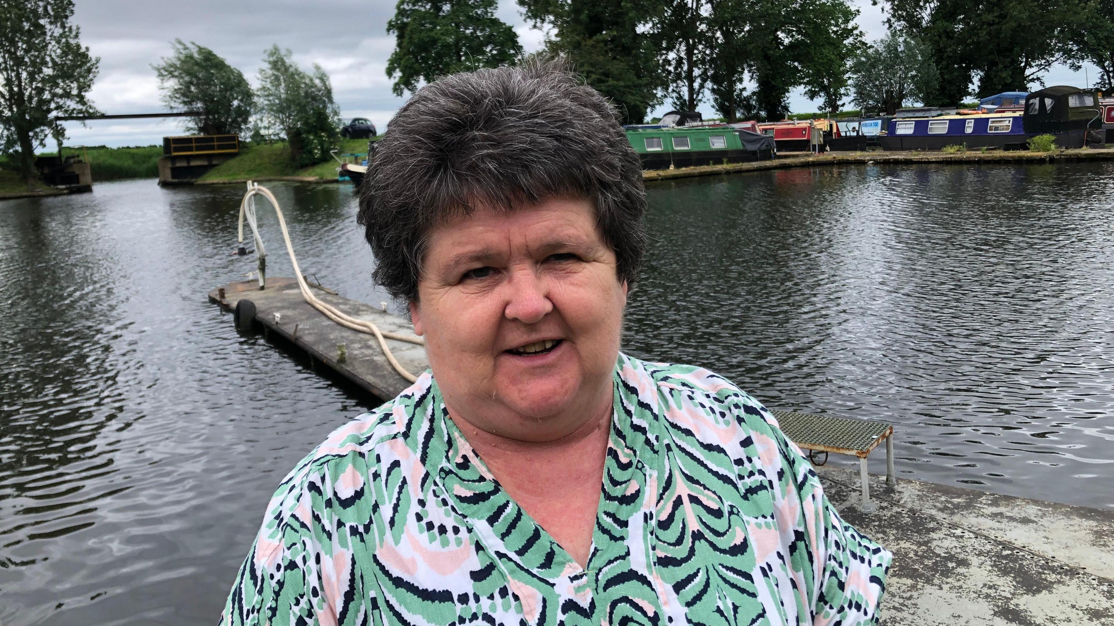 Paula Syred with the Fox boatyard behind her