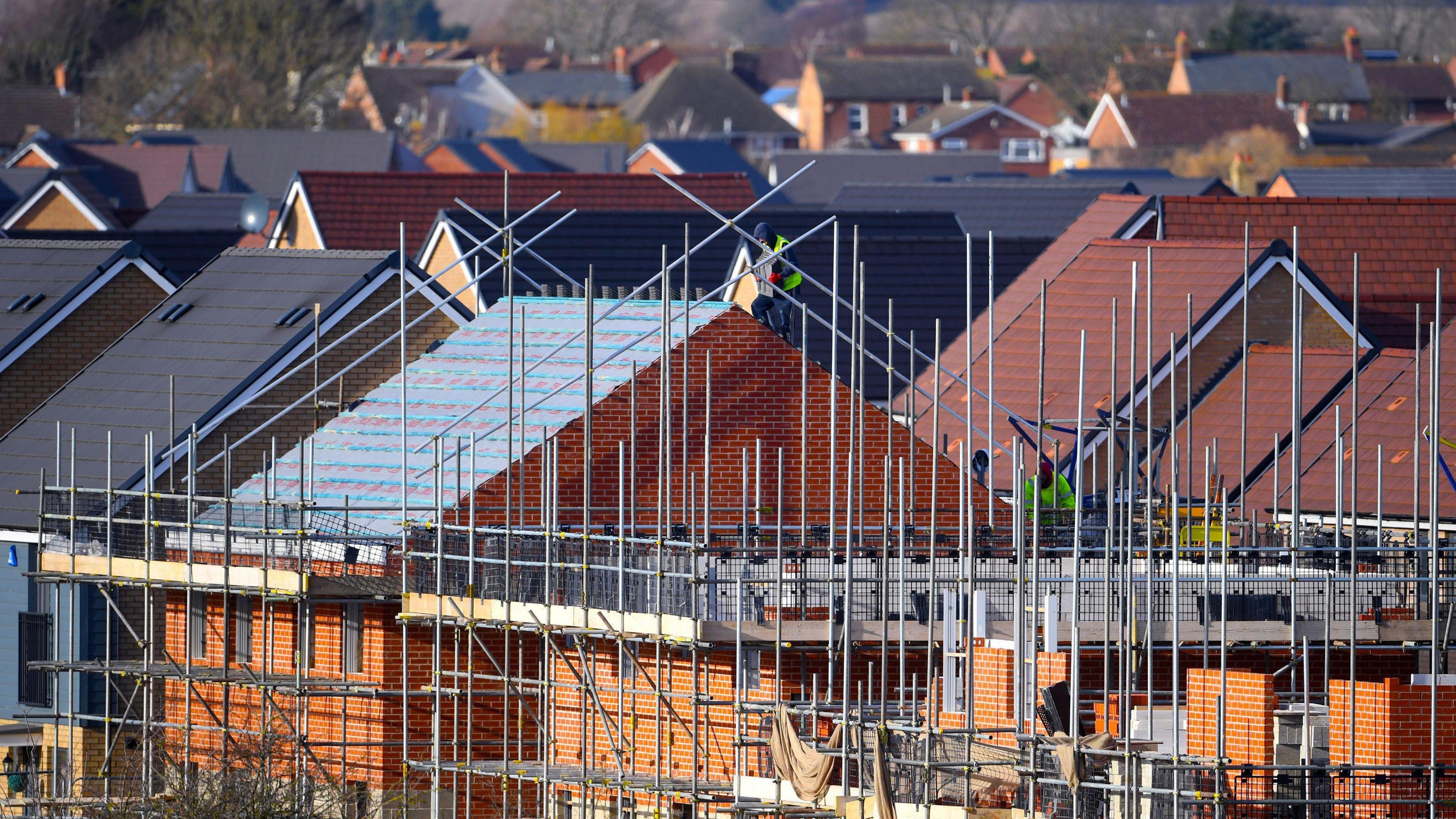 Scaffolding surrounding houses 