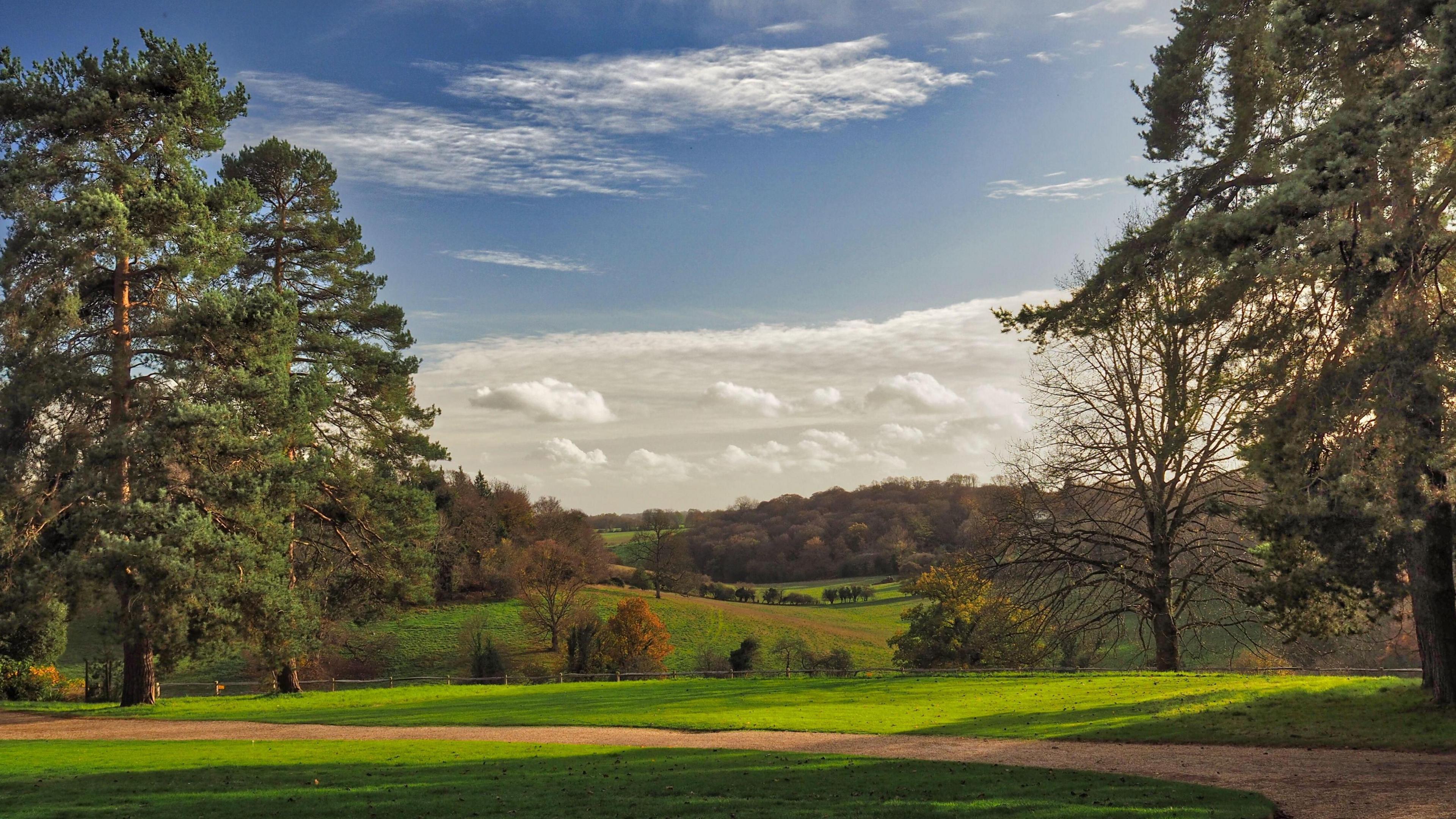 Green hills and forests roll back into the distance.