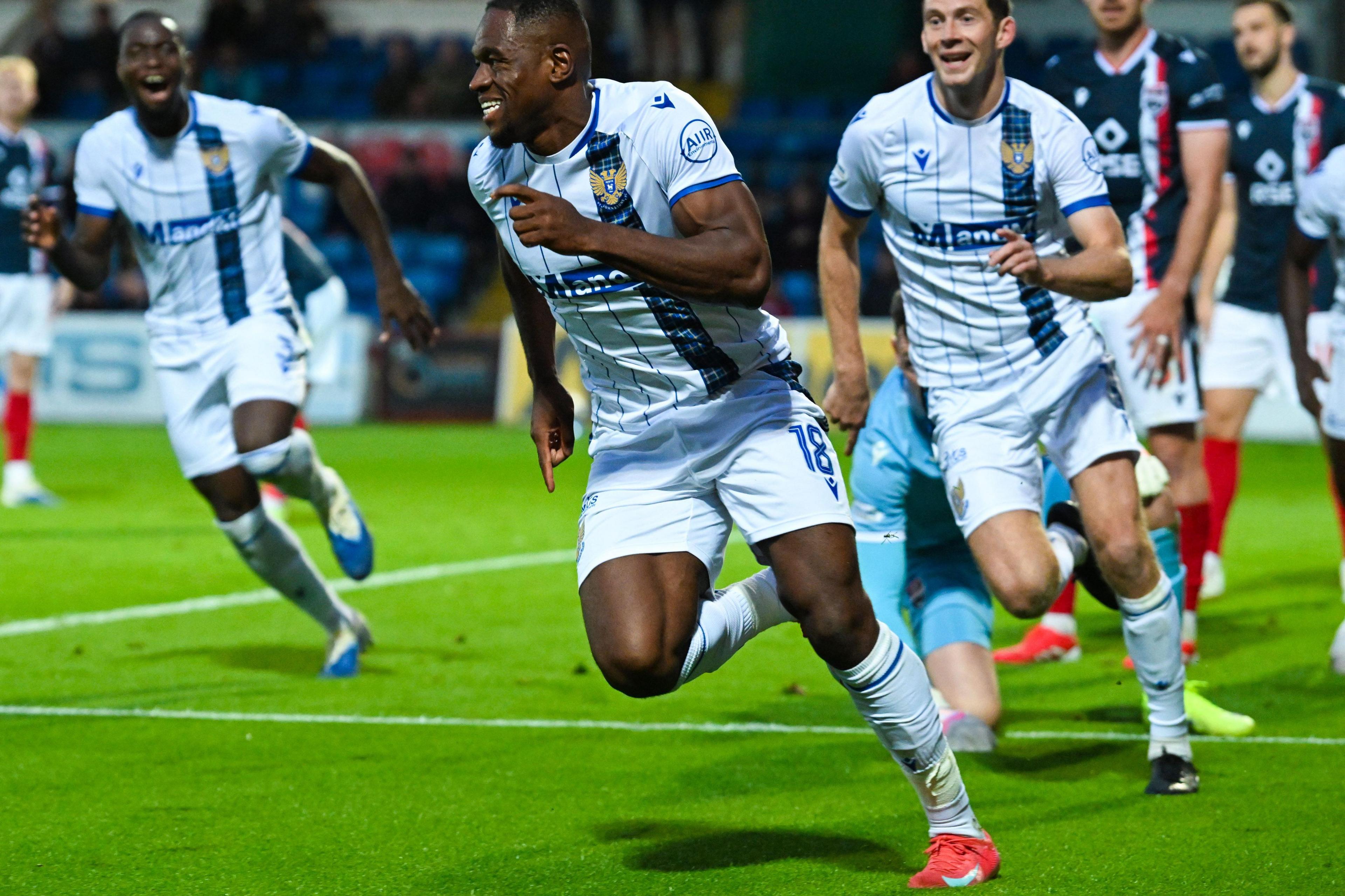 Uche Ikpeazu runs down the pitch after scoring his goal followed by fellow players.