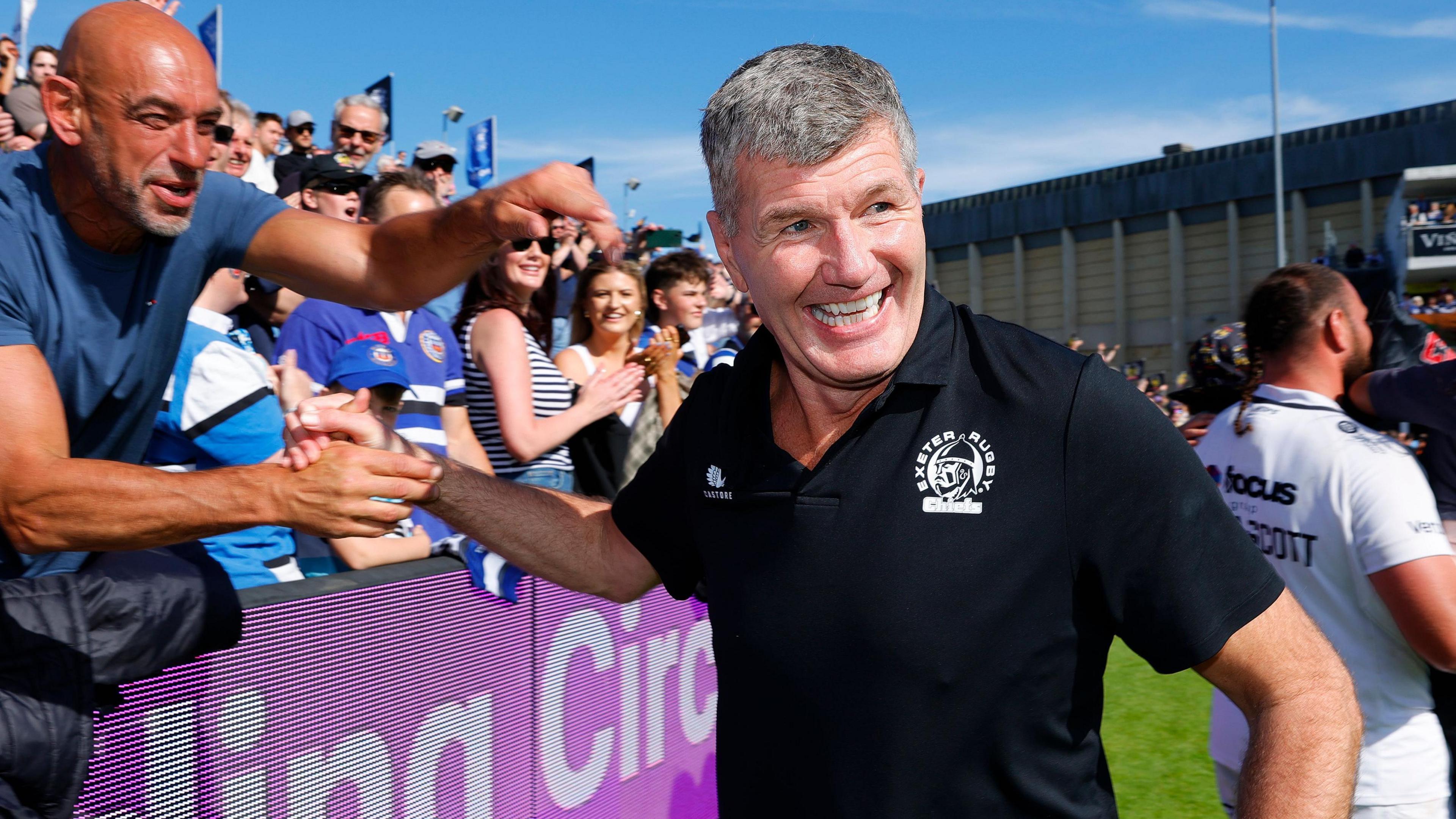 Rob Baxter is congratulated by Exeter fans