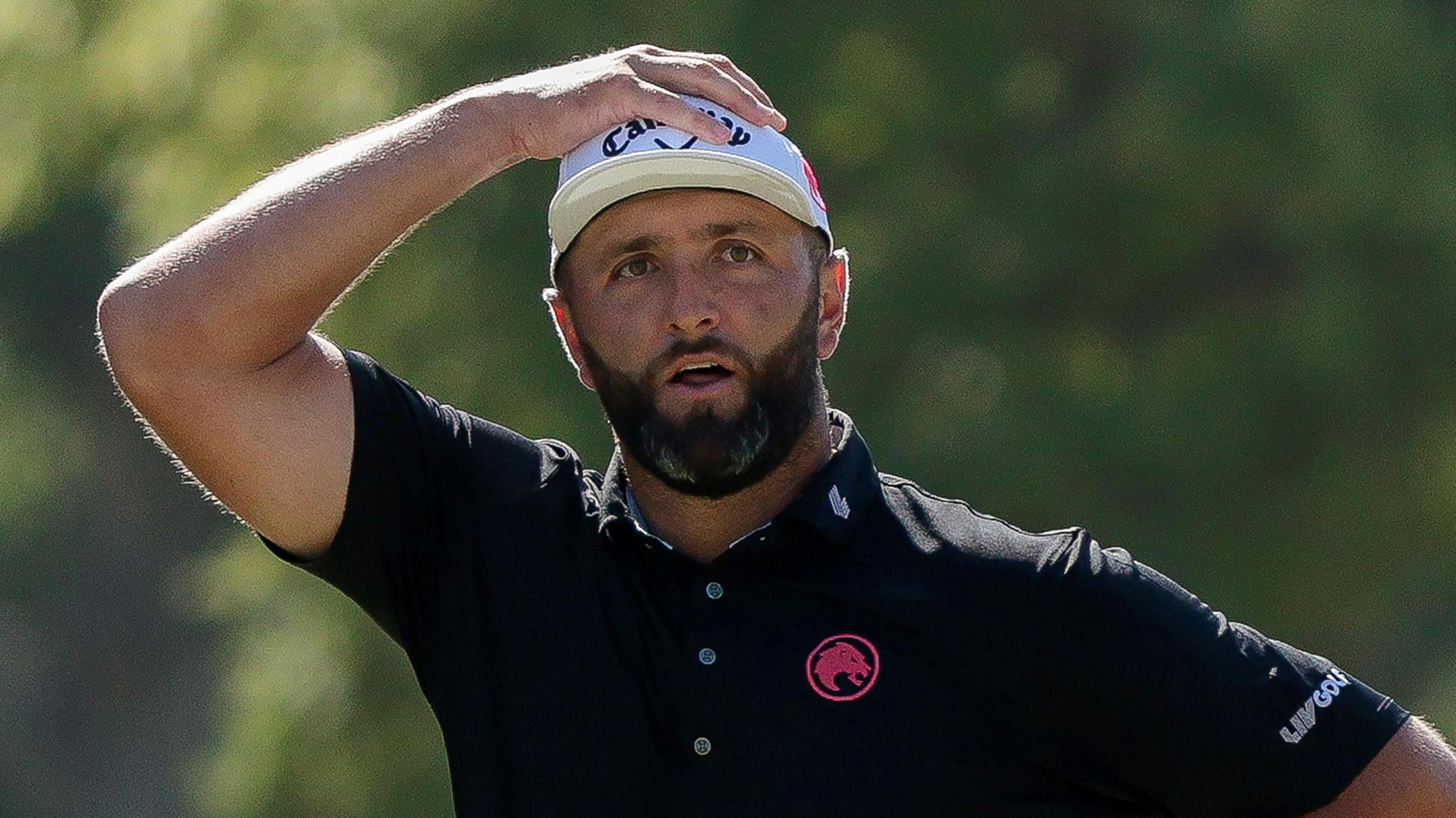 Jon Rahm has his hand on his head
