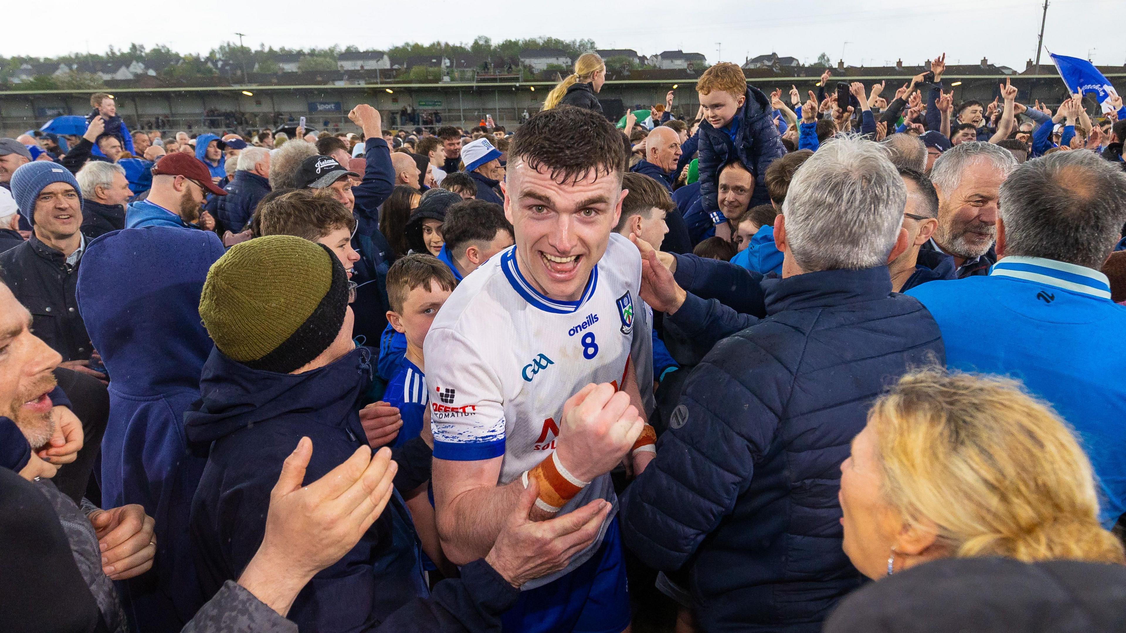 Micheal McCarville celebrates as Monaghan fans flood the pitch 