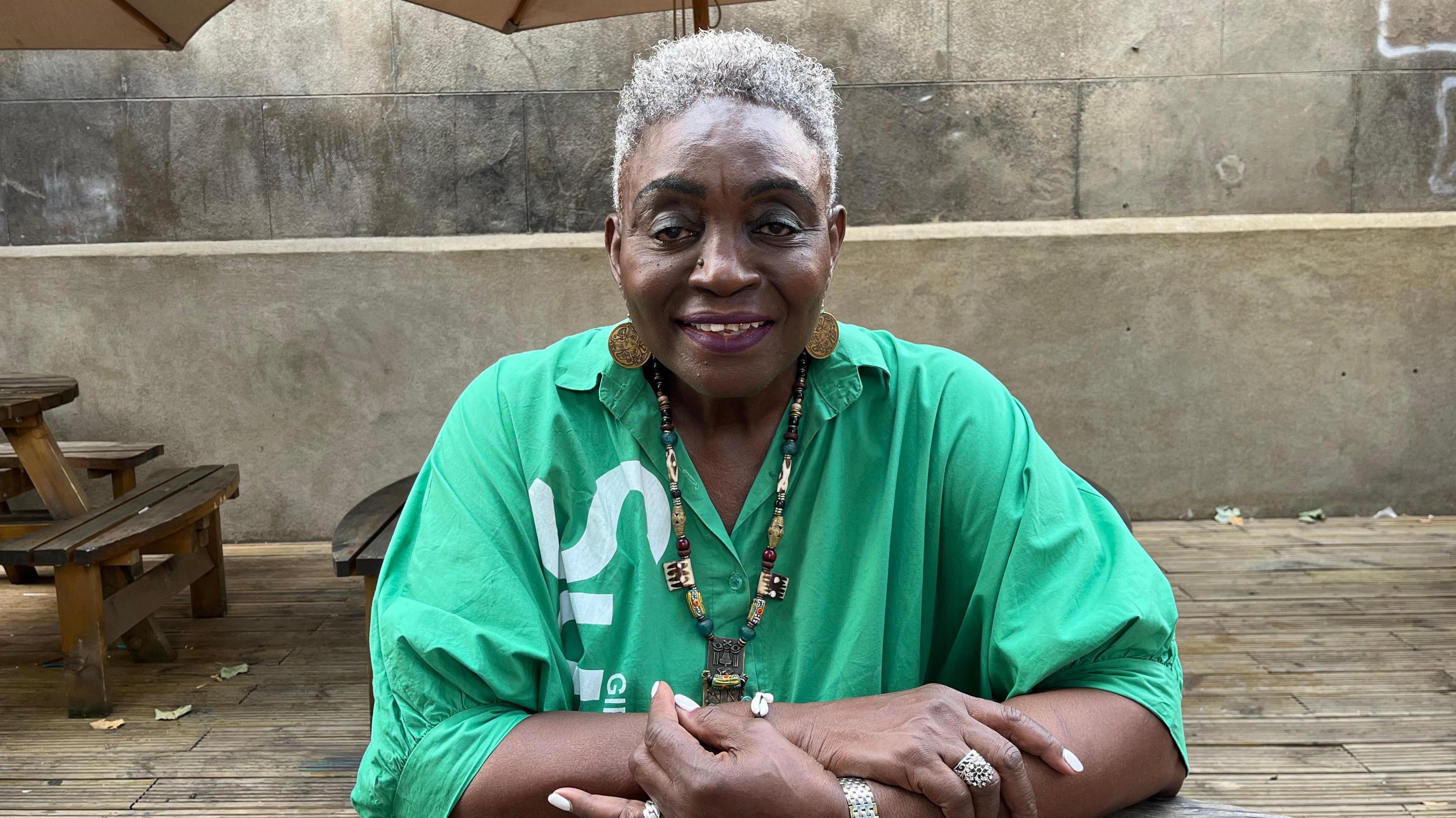 Allyson Williams sits at an outdoor table in west London while discussing Notting Hill Carnival ahead of its 60th anniversary.