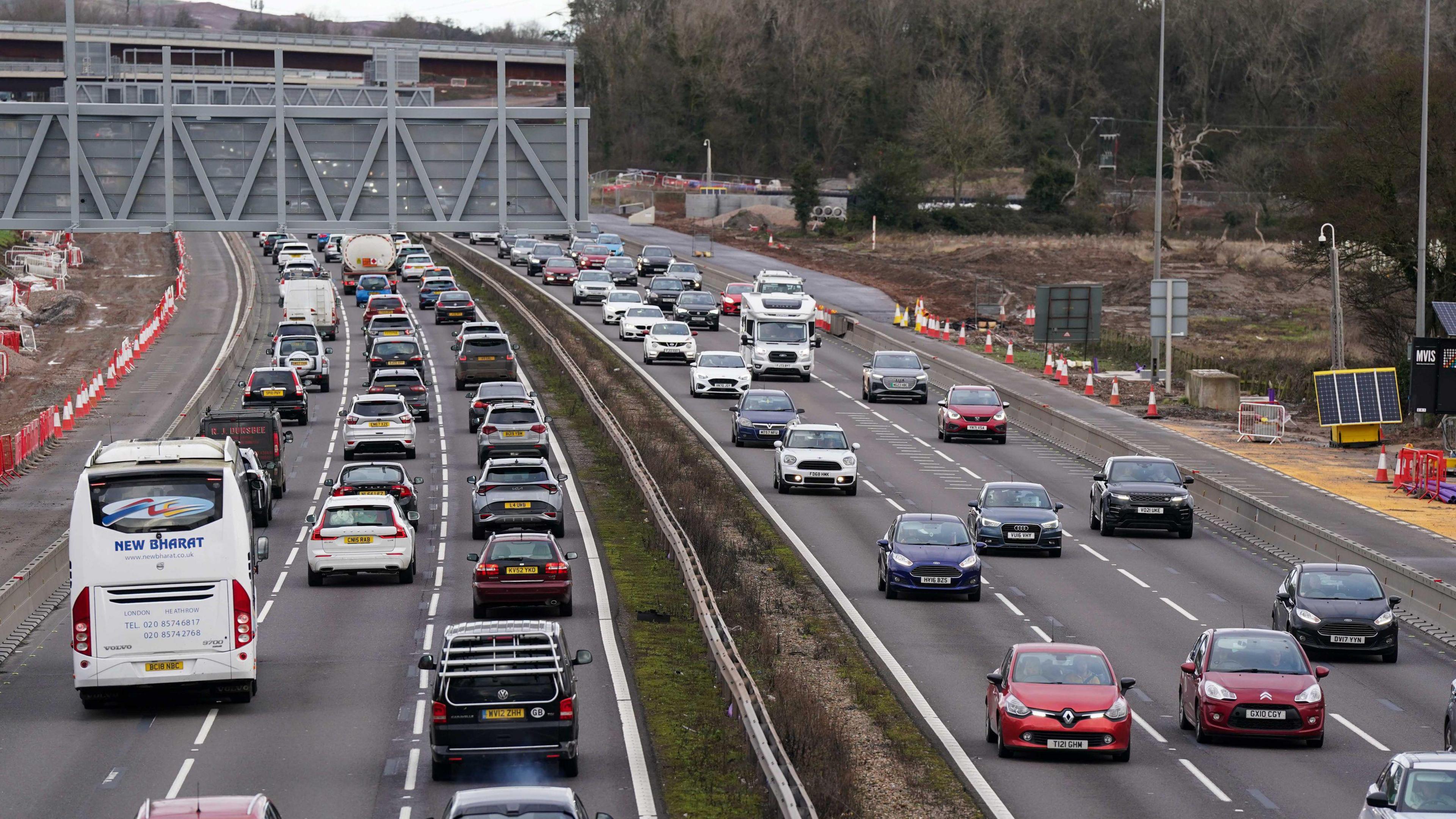 A picture taken from a motorway bridge showing a busy motorway.