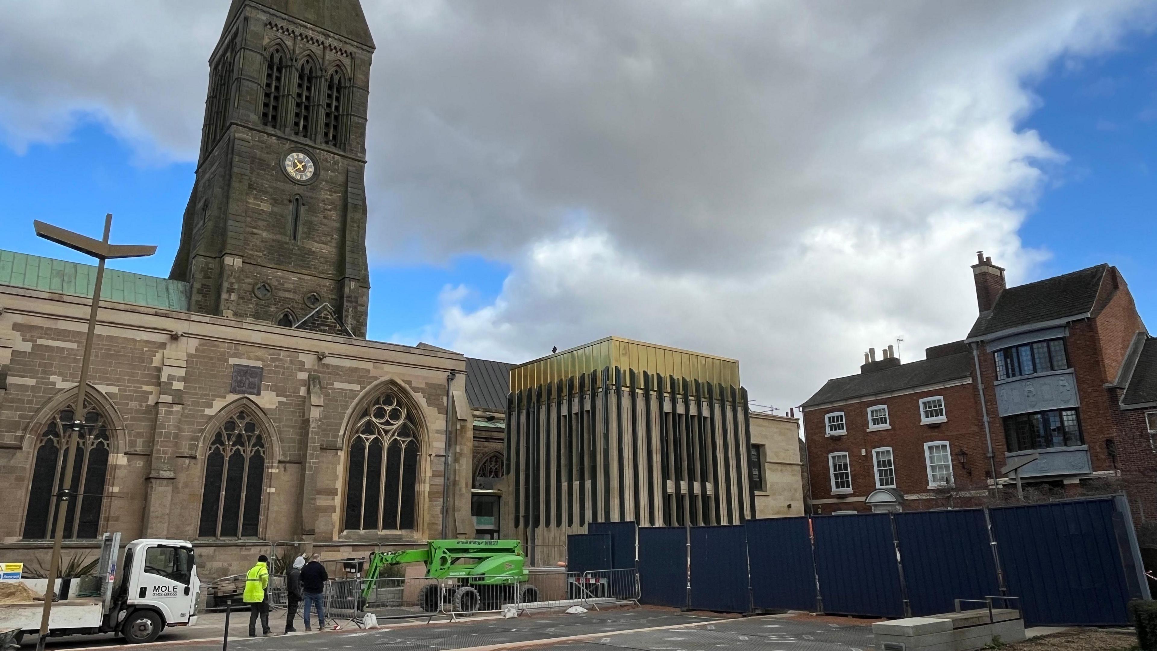 The front of Leicester Cathedral with the newly-built heritage centre with its copper roof