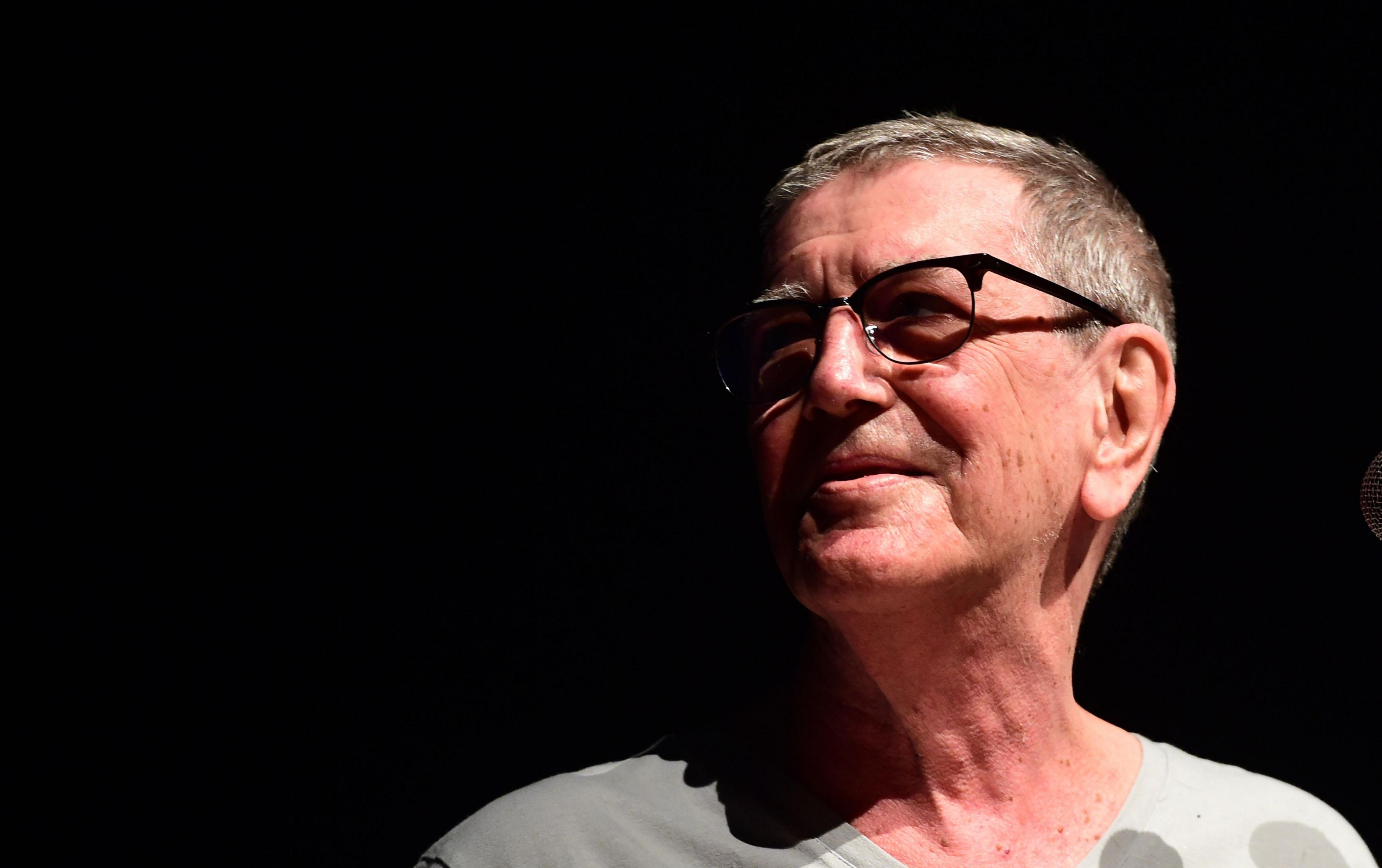 Howard Marks pictured at The Forum in Kentish Town, London, in February 2015. He has short grey hair and glasses and is wearing a cream t-shirt. 