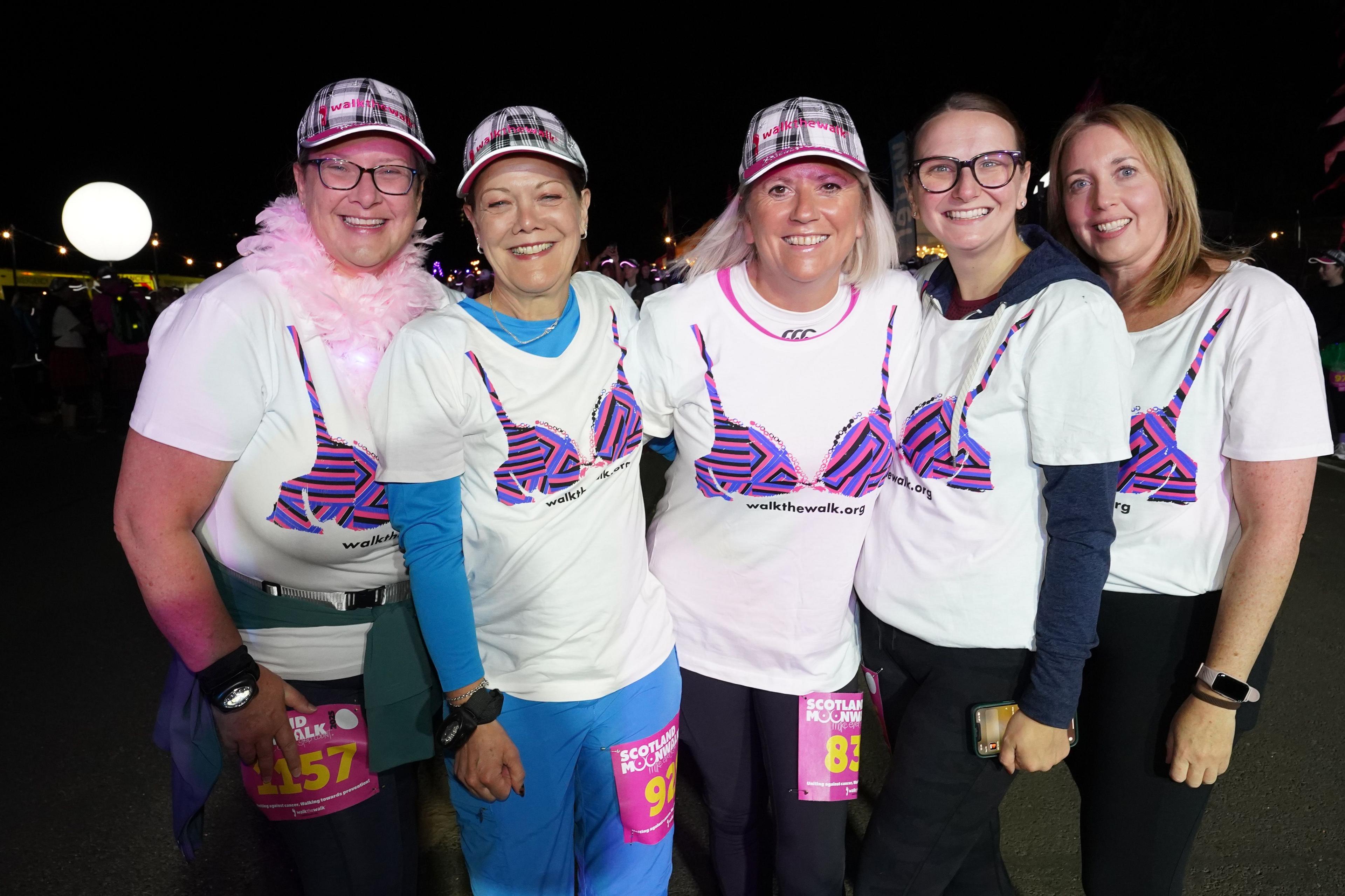 Five women in white T-Shirts with a colourful bra pattern on the front of them