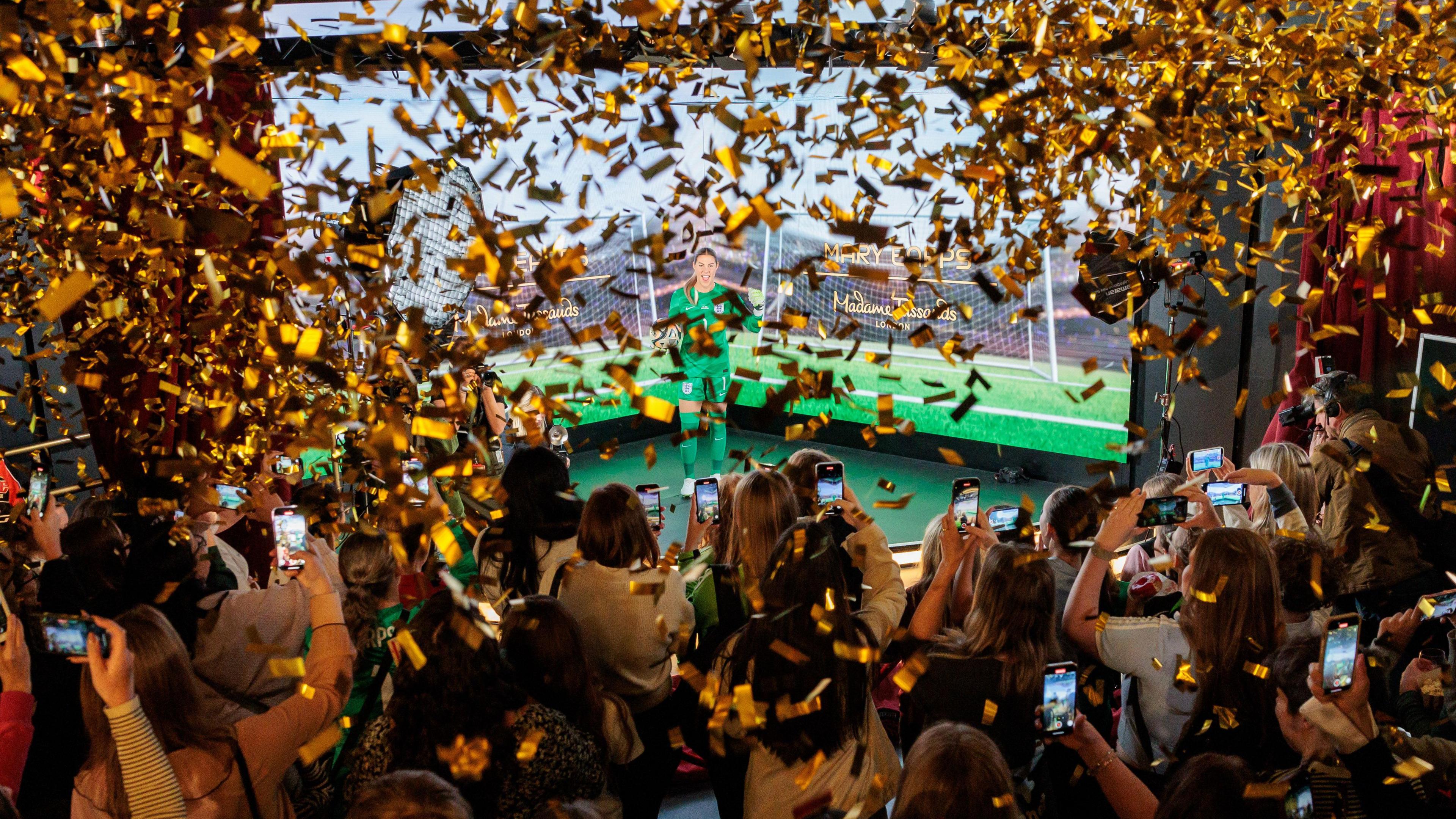 confetti firing and lots of people taking pictures of Mary's figure