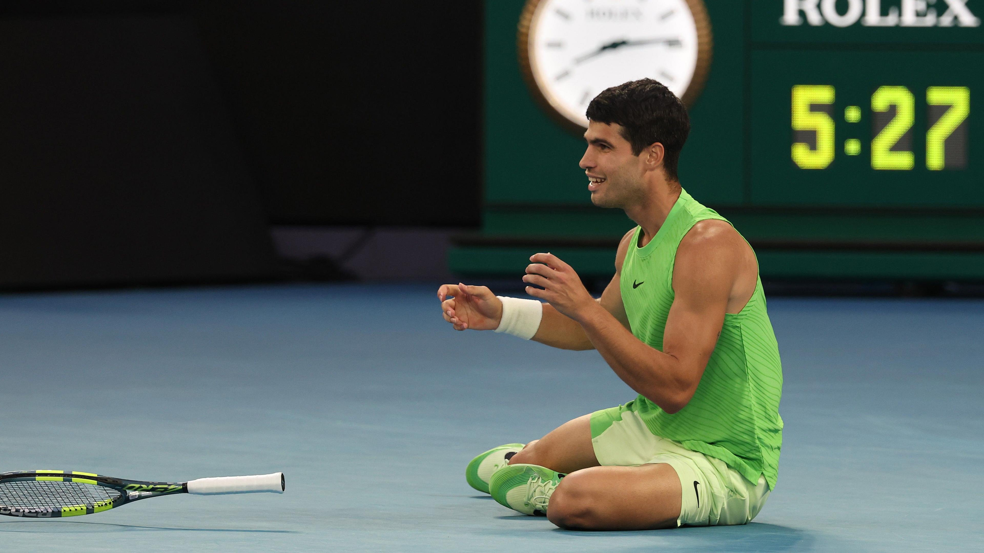 Carlos Alcaraz falls to the floor after beating Alexander Zverev