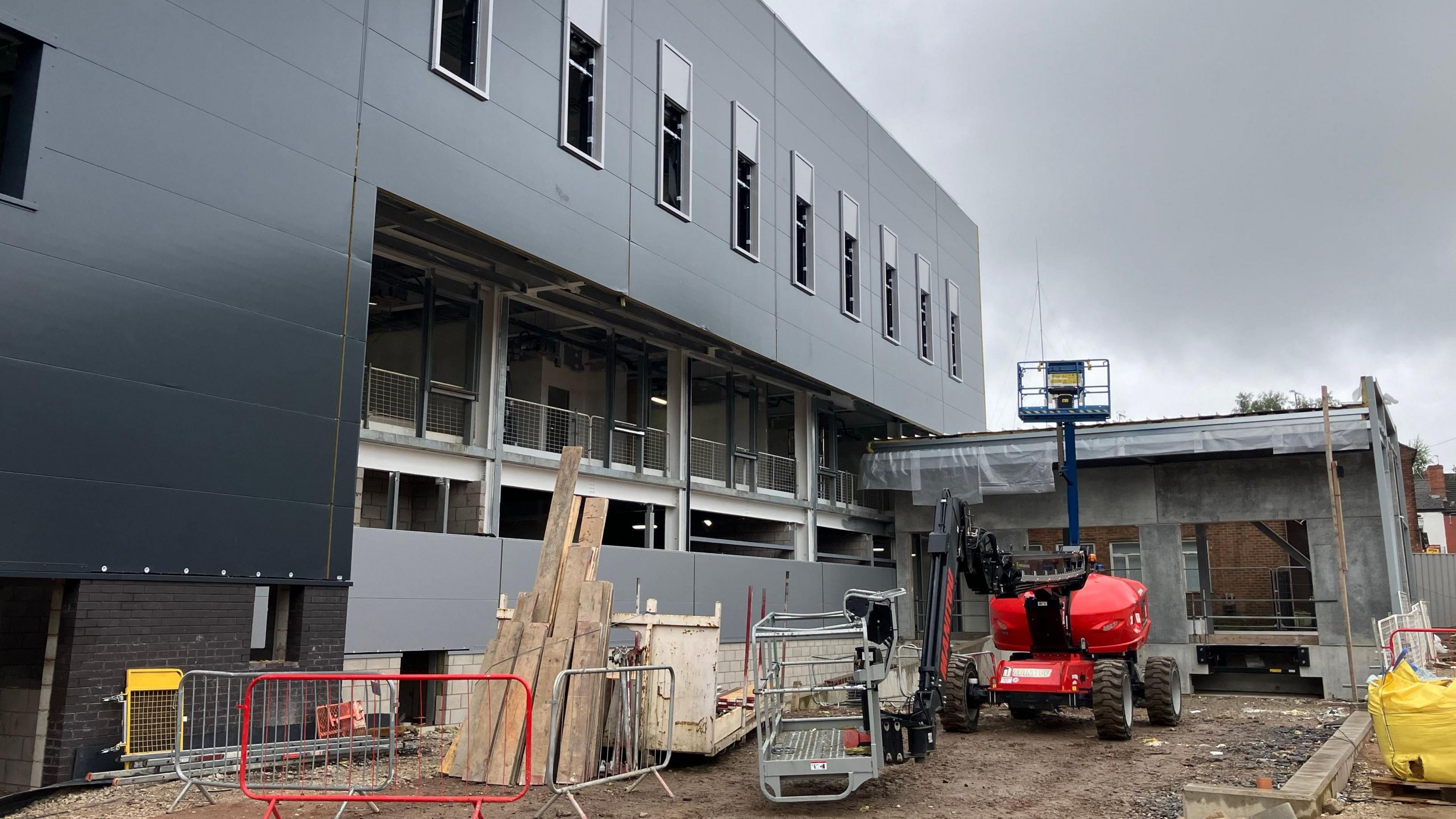 Exterior of Becketwell Arena, clad mostly in black panels