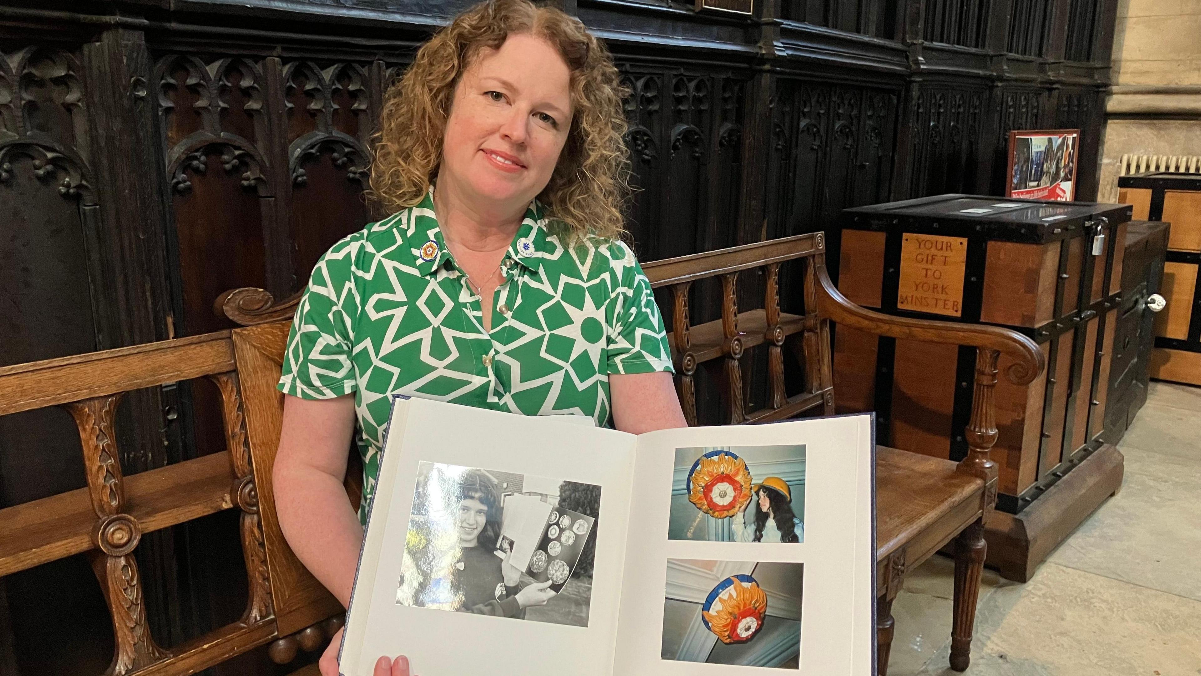 Laura is pictured sitting in the Minster holding up a scrapbook that contains childhood photos of her with her boss design