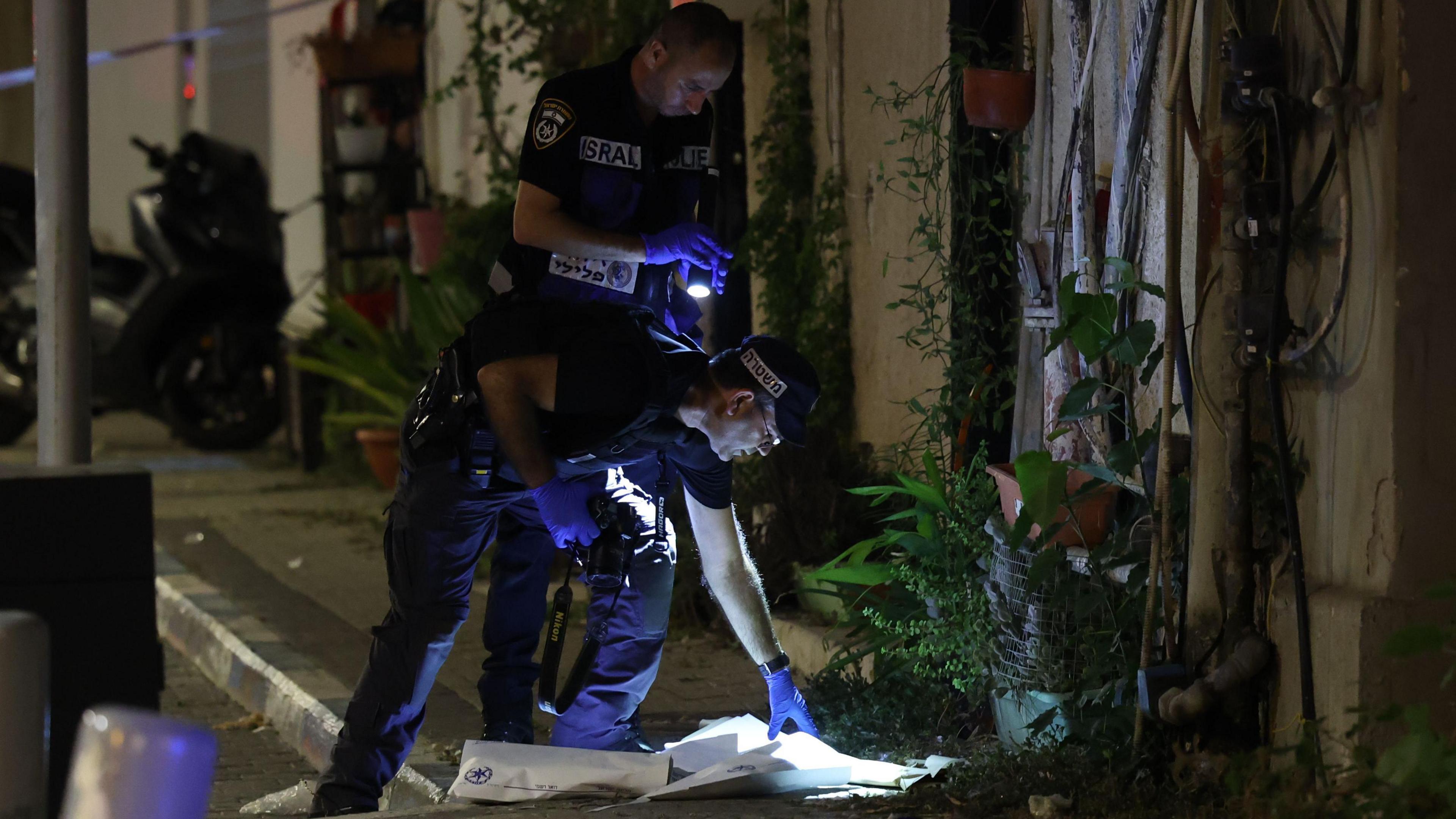 Police inspect the scene of the attack