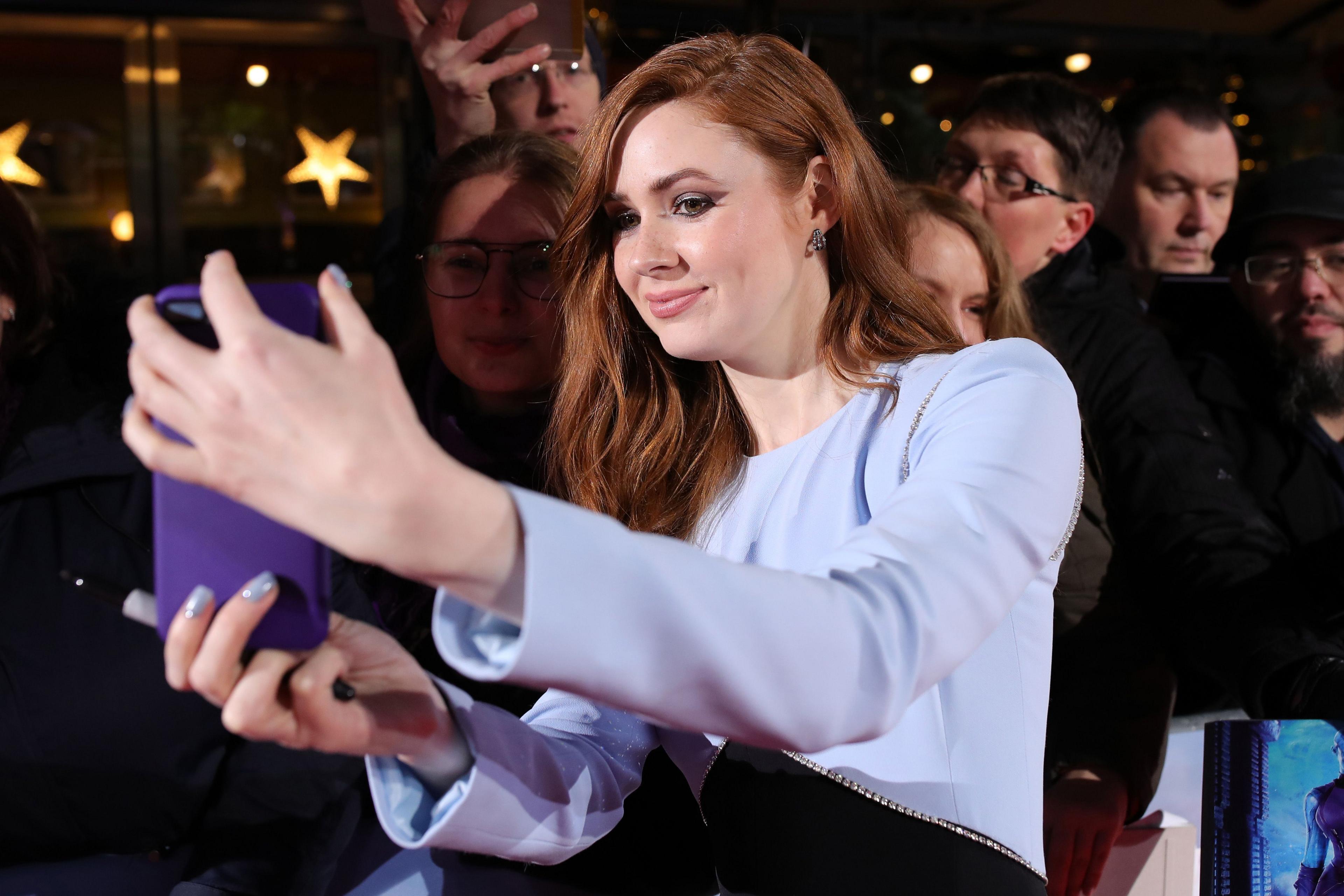 Karen Gillan taking a selfie with a fan