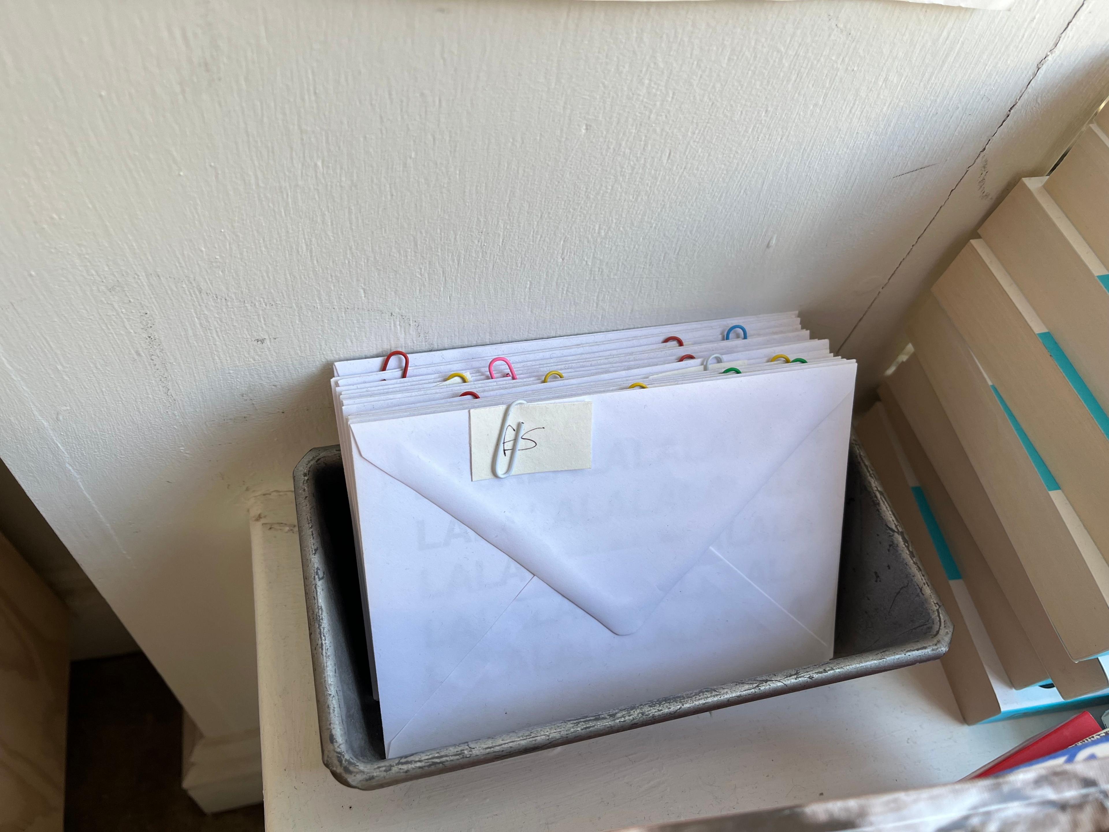 A box with envelopes standing upright containing gift vouchers 