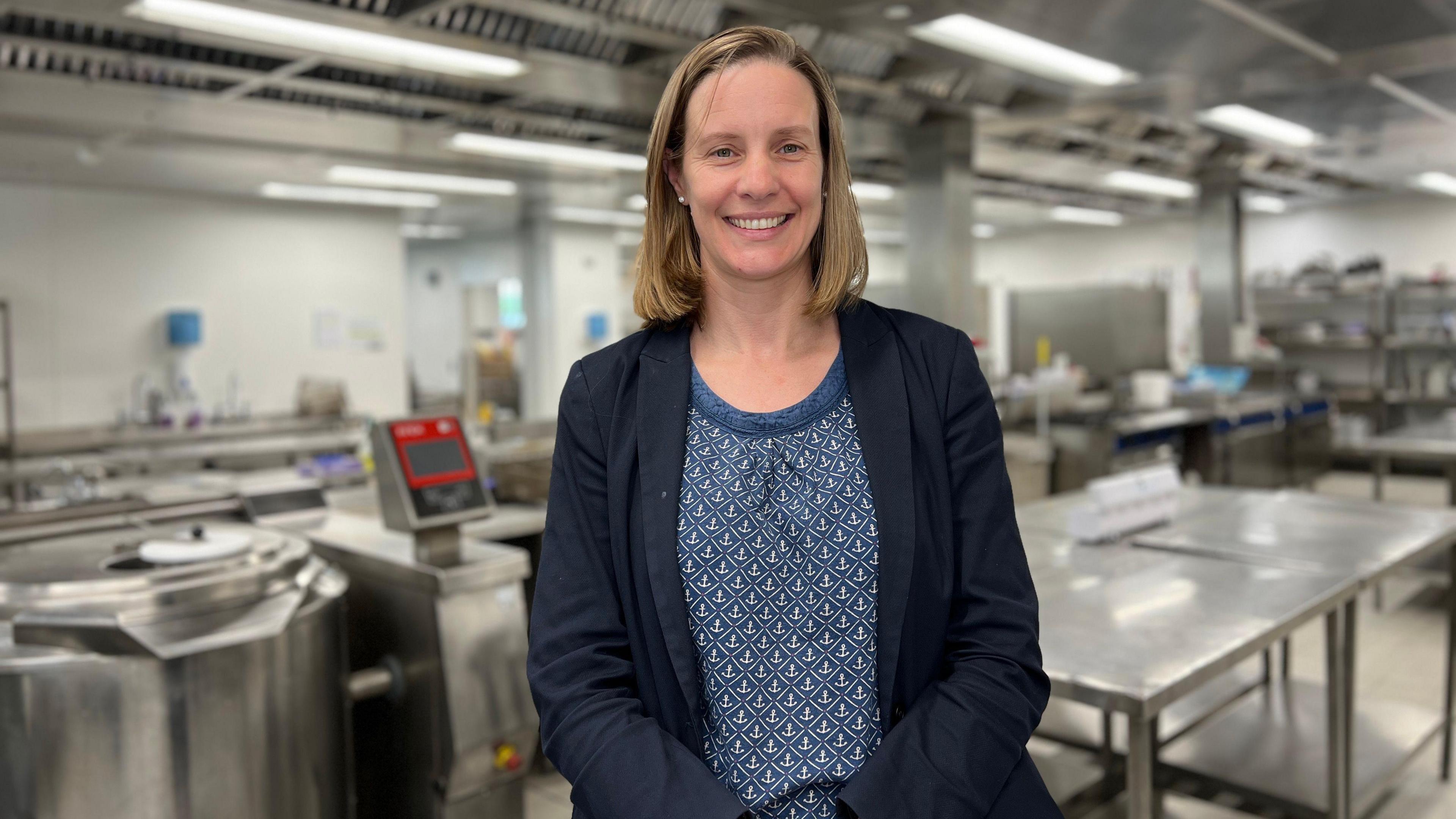 Governor for the States of Jersey Prison Service, Susie Richardson stands in HMP La Moye kitchen smiling at the camera