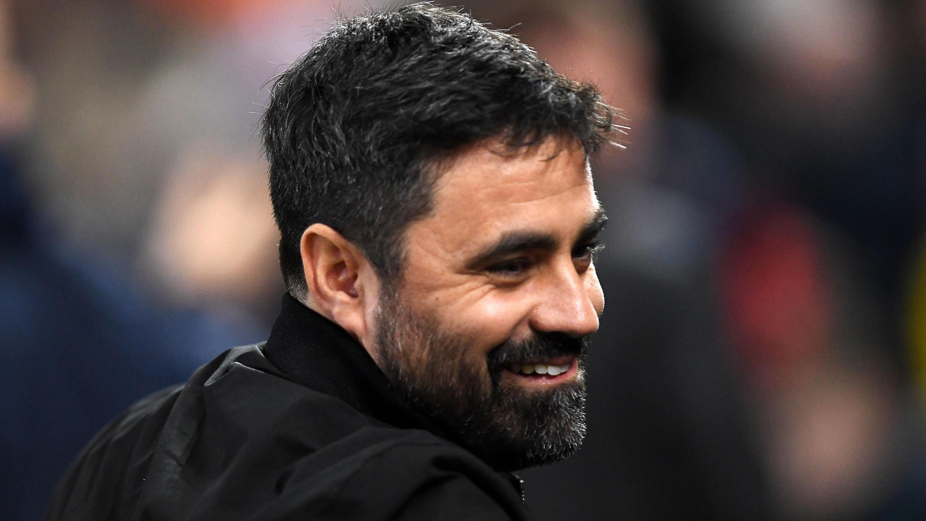 Swansea head coach Vitor Matos smiles on the touchline 