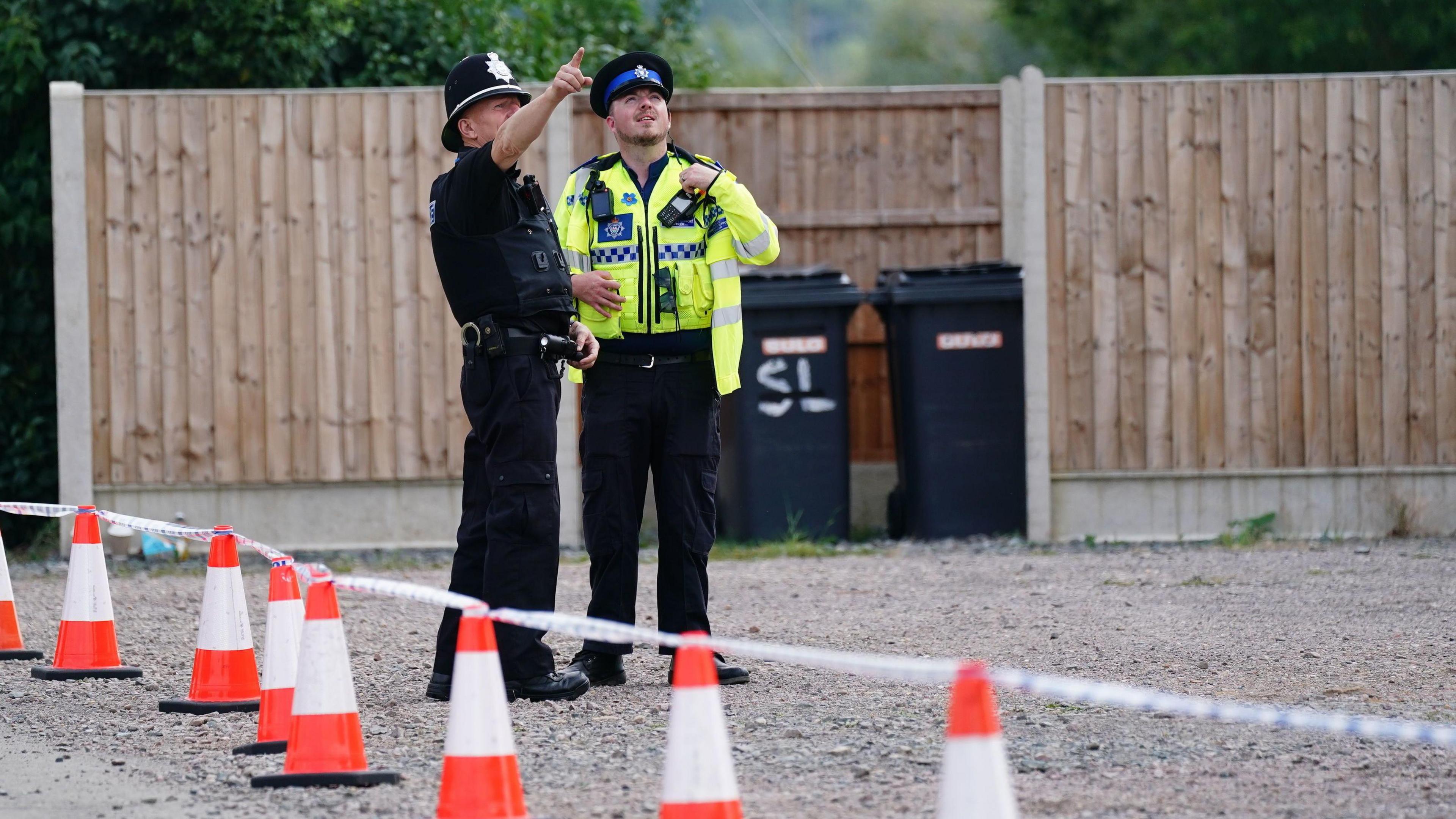 Two police officers near a cordon