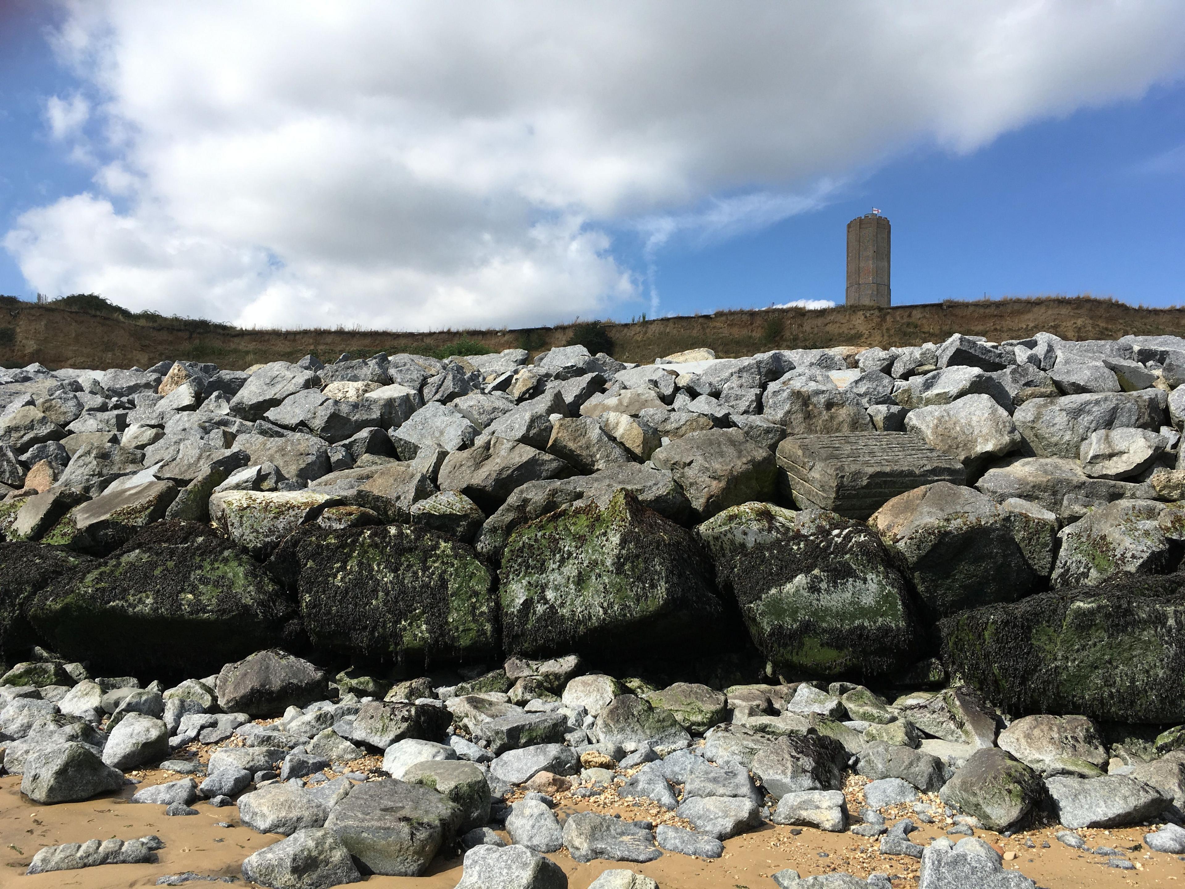 Sea defence rocks at The Naze, Walton-on-the-Naze, Essex with Naze Tower visible