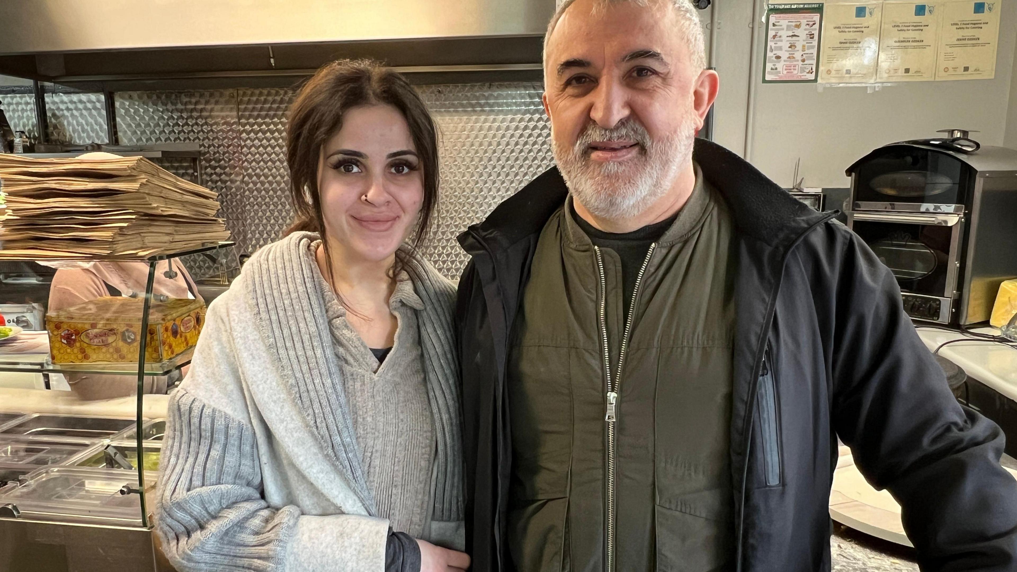 Father and daughter smile inside their family's Turkish kitchen inside Castle Place