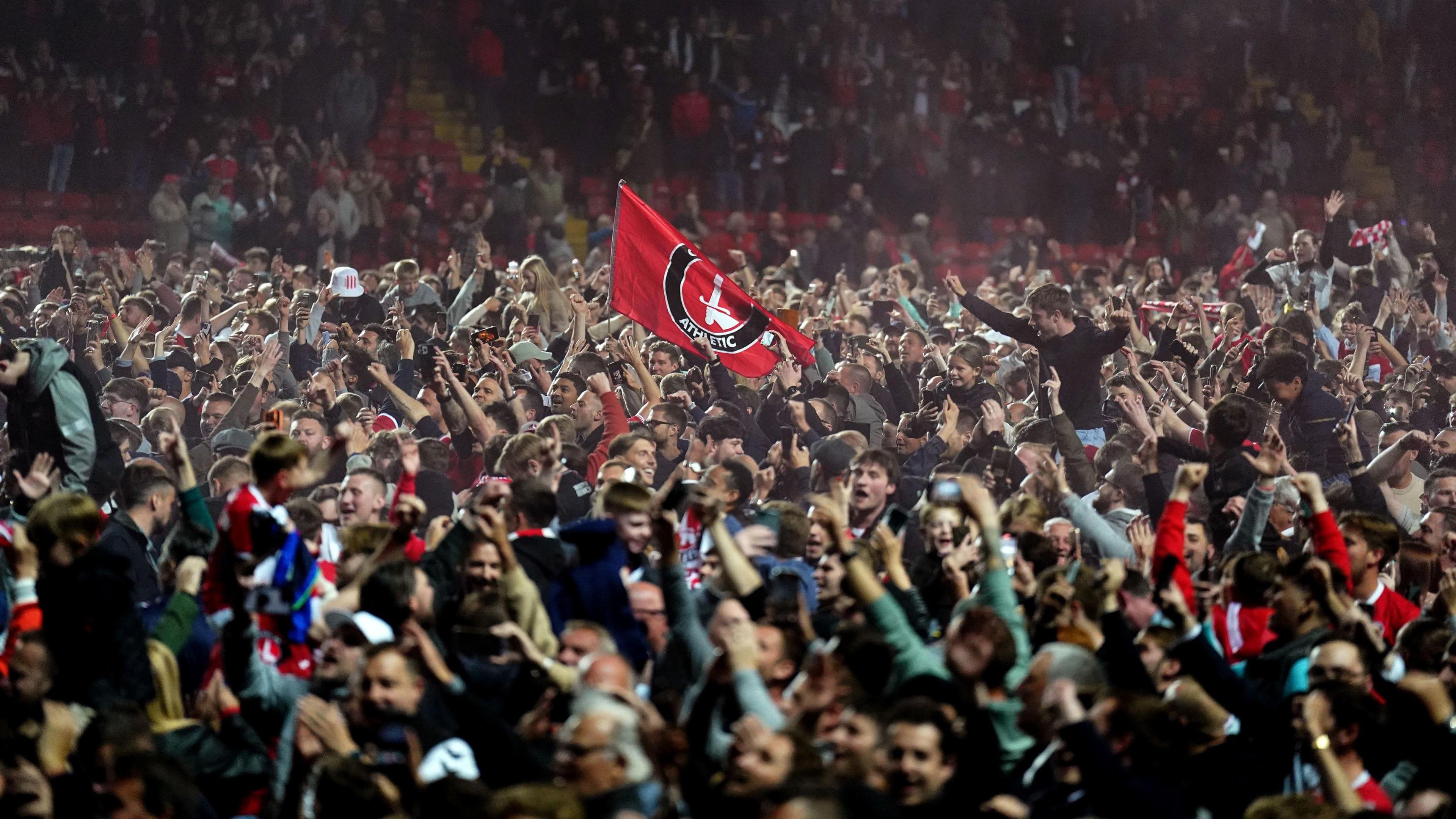 Charlton fans on the pitch