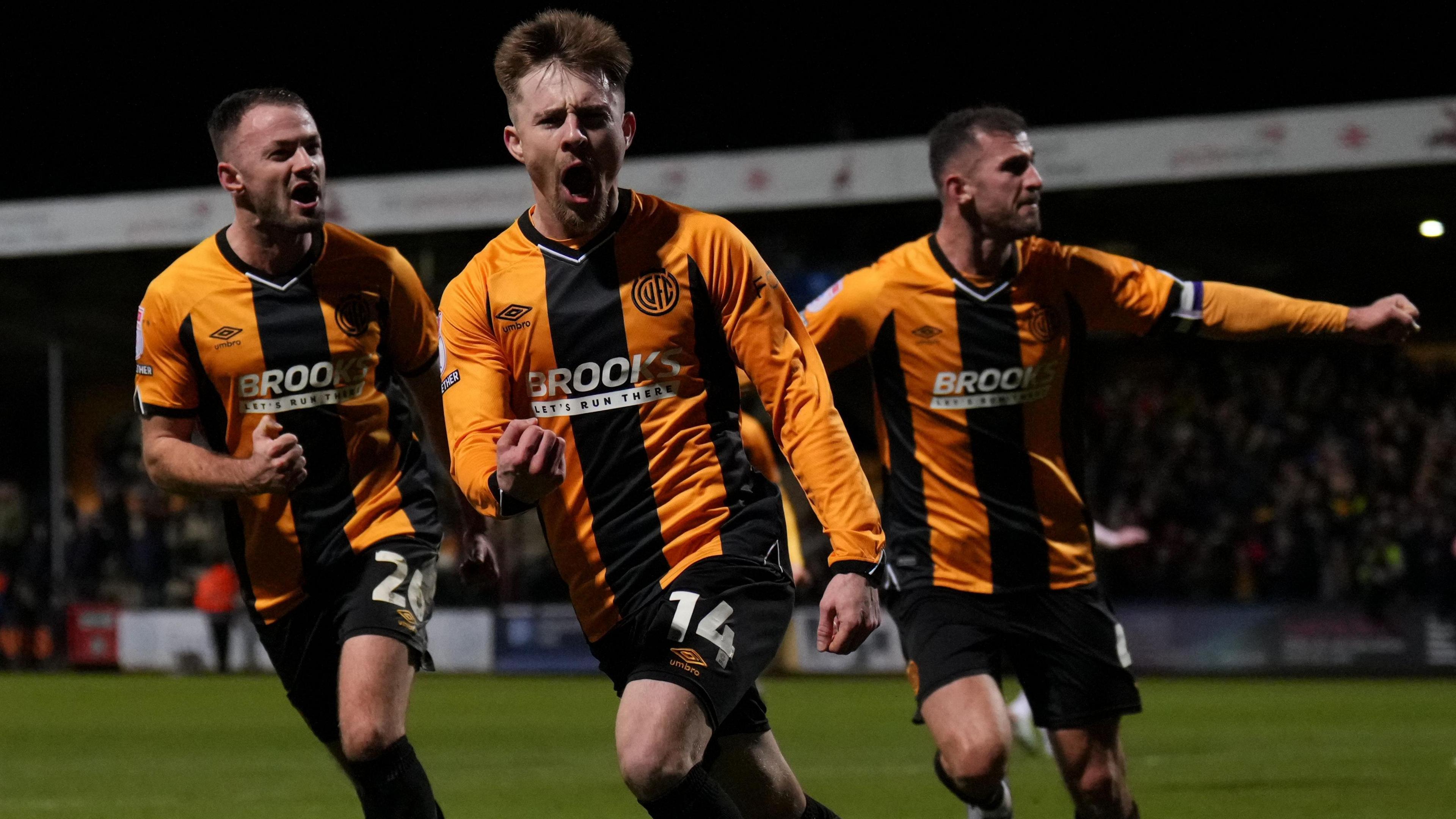 Ben Knight celebrating with team-mates after scoring the last-minute winner for Cambridge United against Shrewsbury