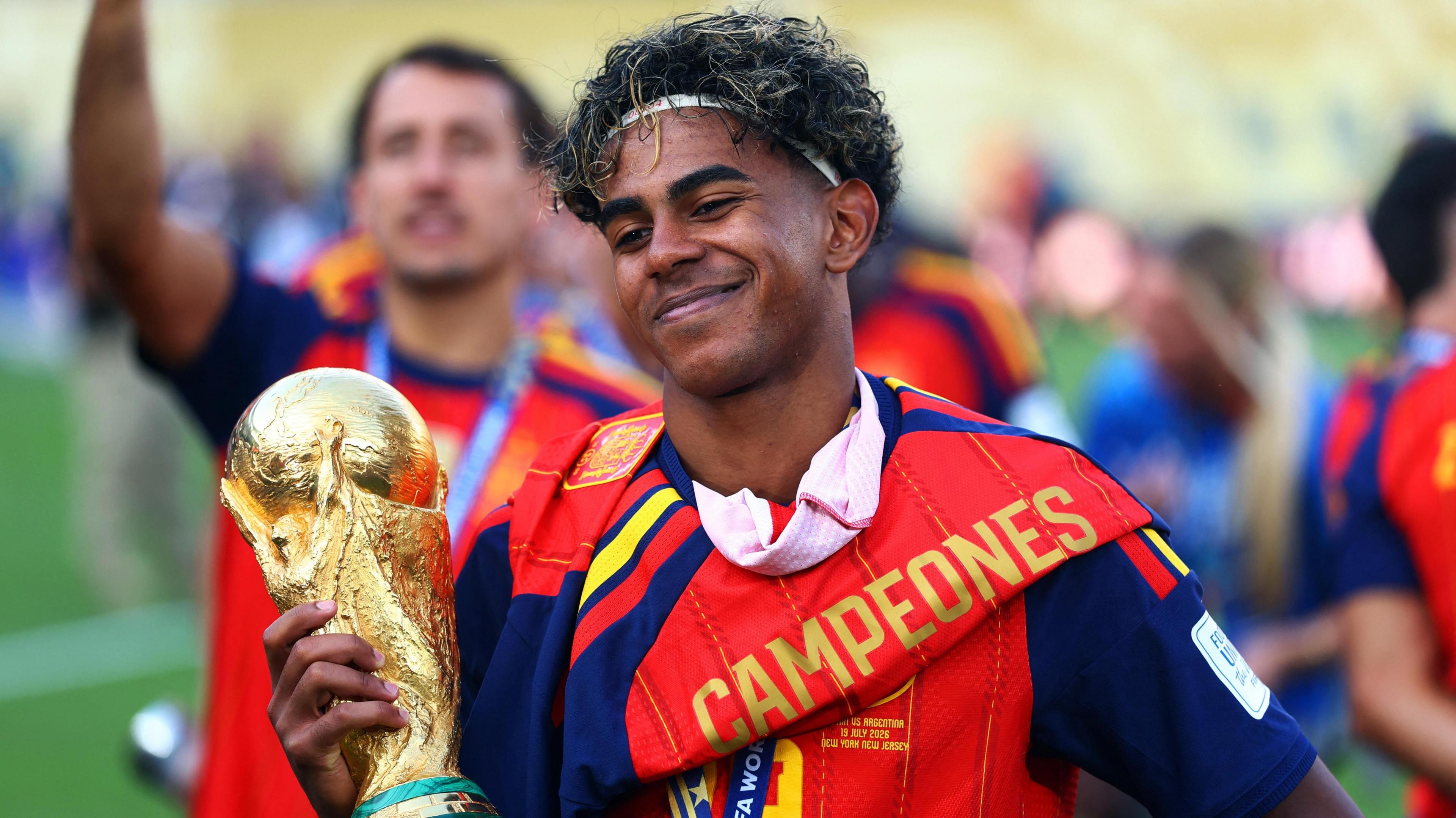 Spain's Lamine Yamal smiles as he celebrates with the World Cup trophy after winning the World Cup
