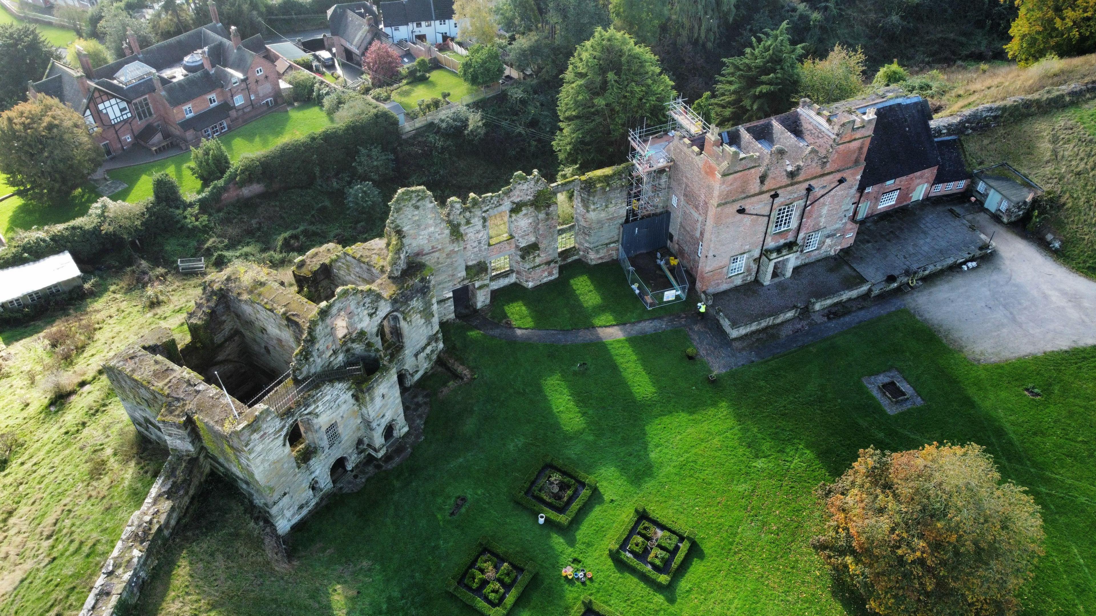 An aerial image taken from a drone of Tutbury Castle showing derelict 11th-century fortifications and the grounds.