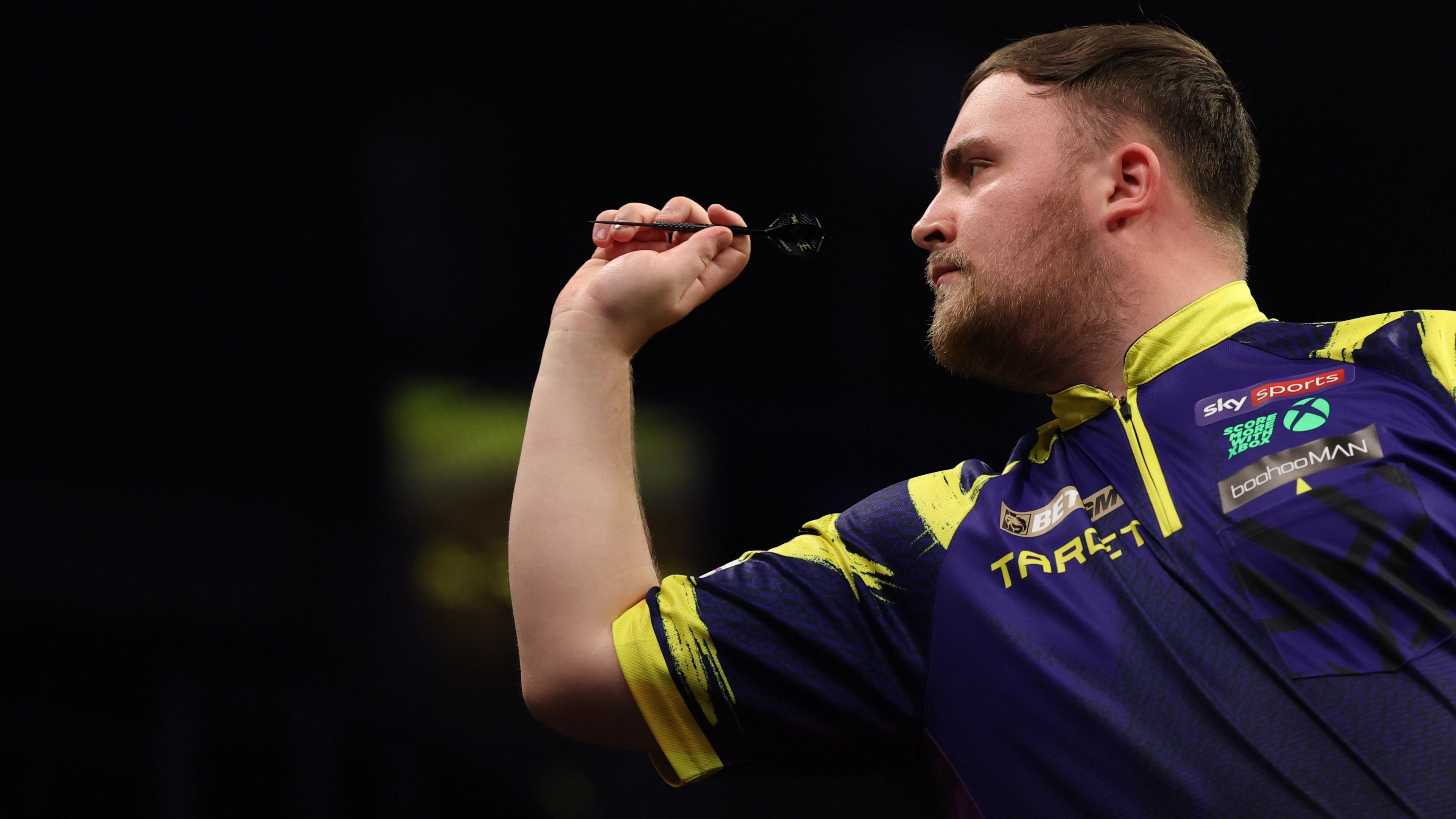 Luke Littler throws a dart