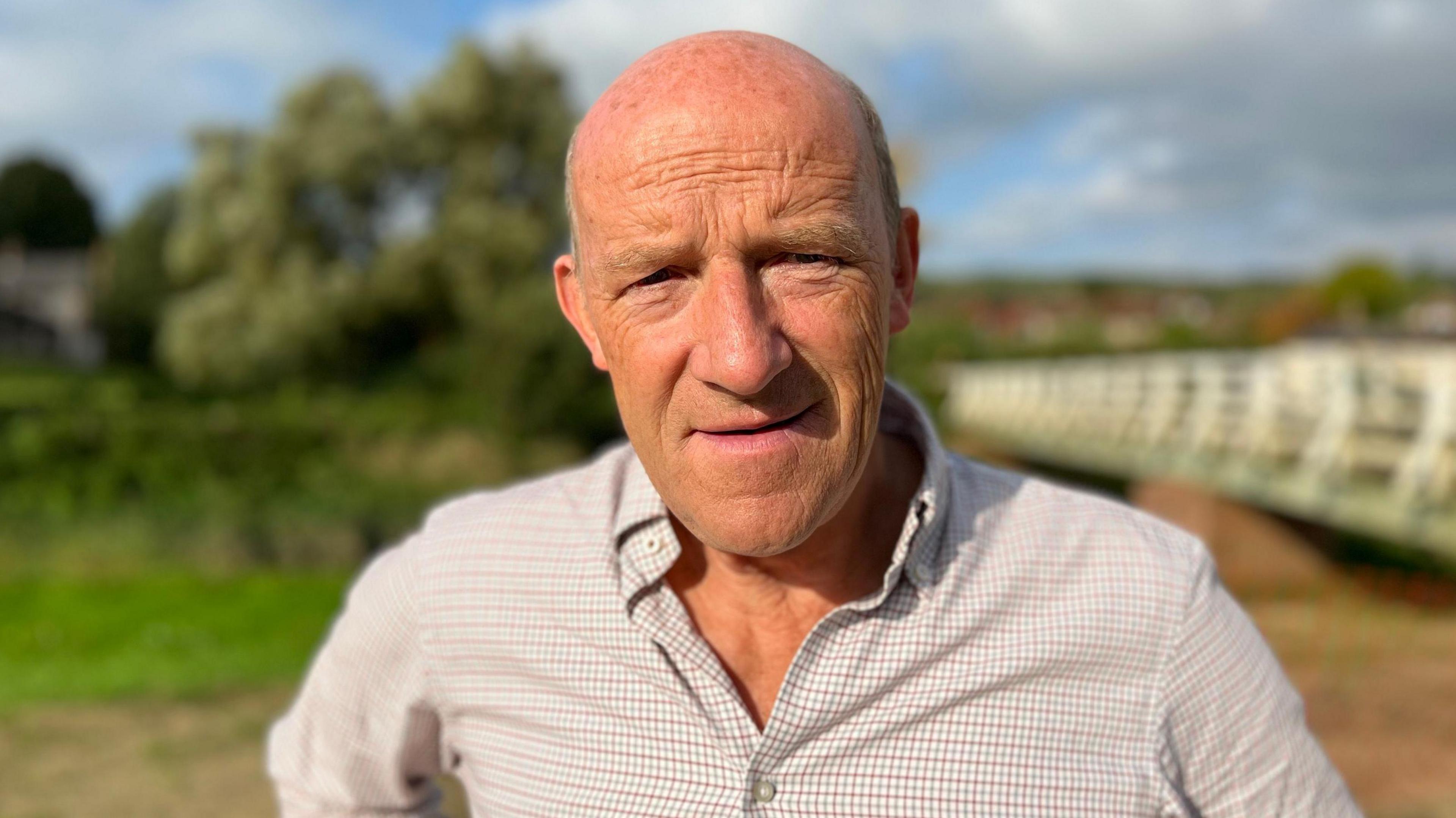 Farmer Richard Brown stood next to the Cuckmere River