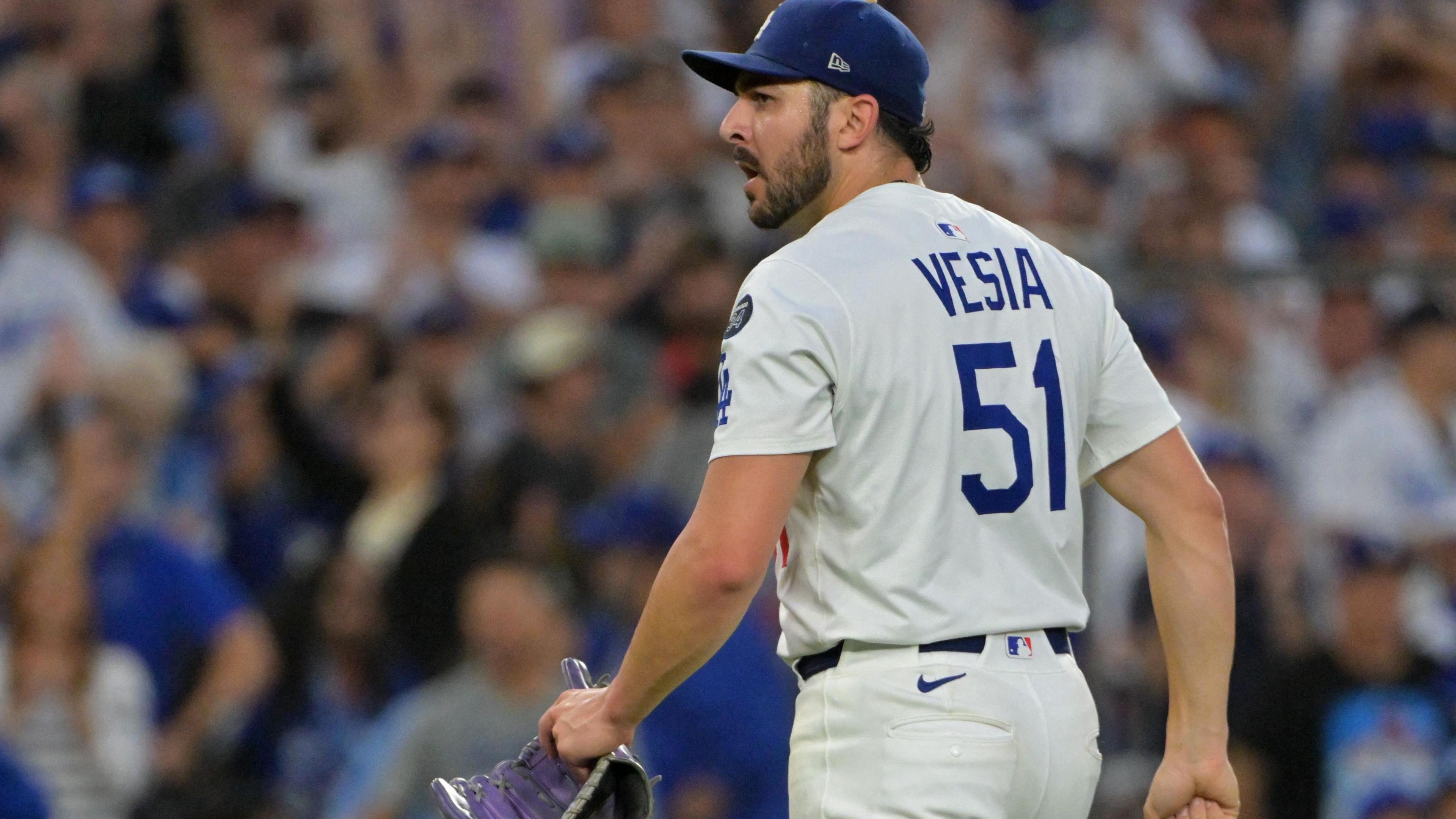 Vesia, wearing No 51 jersey, standing on pitchers' mound, holding his glove, and looking somber