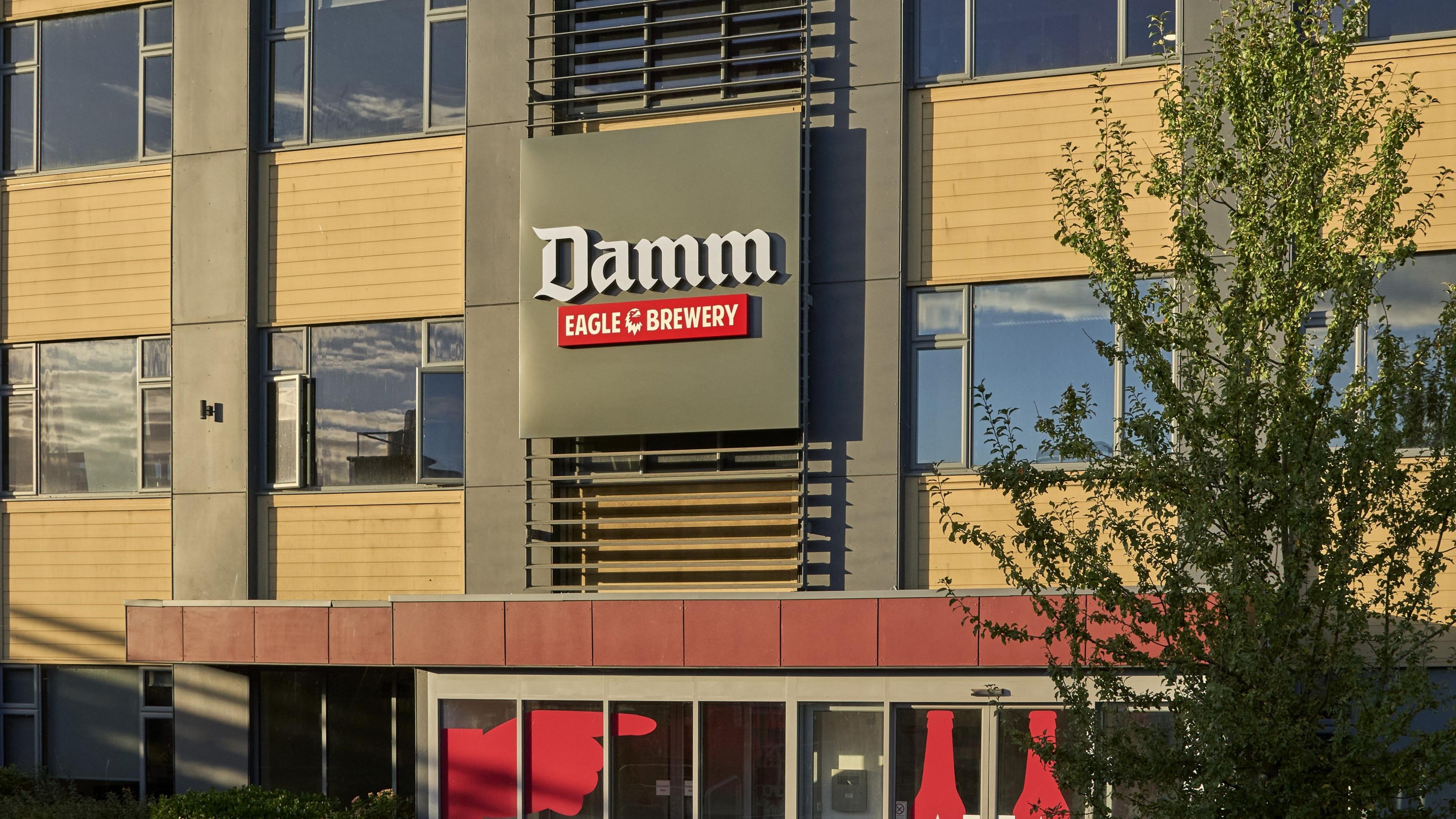 The front of a brewery with the words Damm Eagle Brewery written on it.