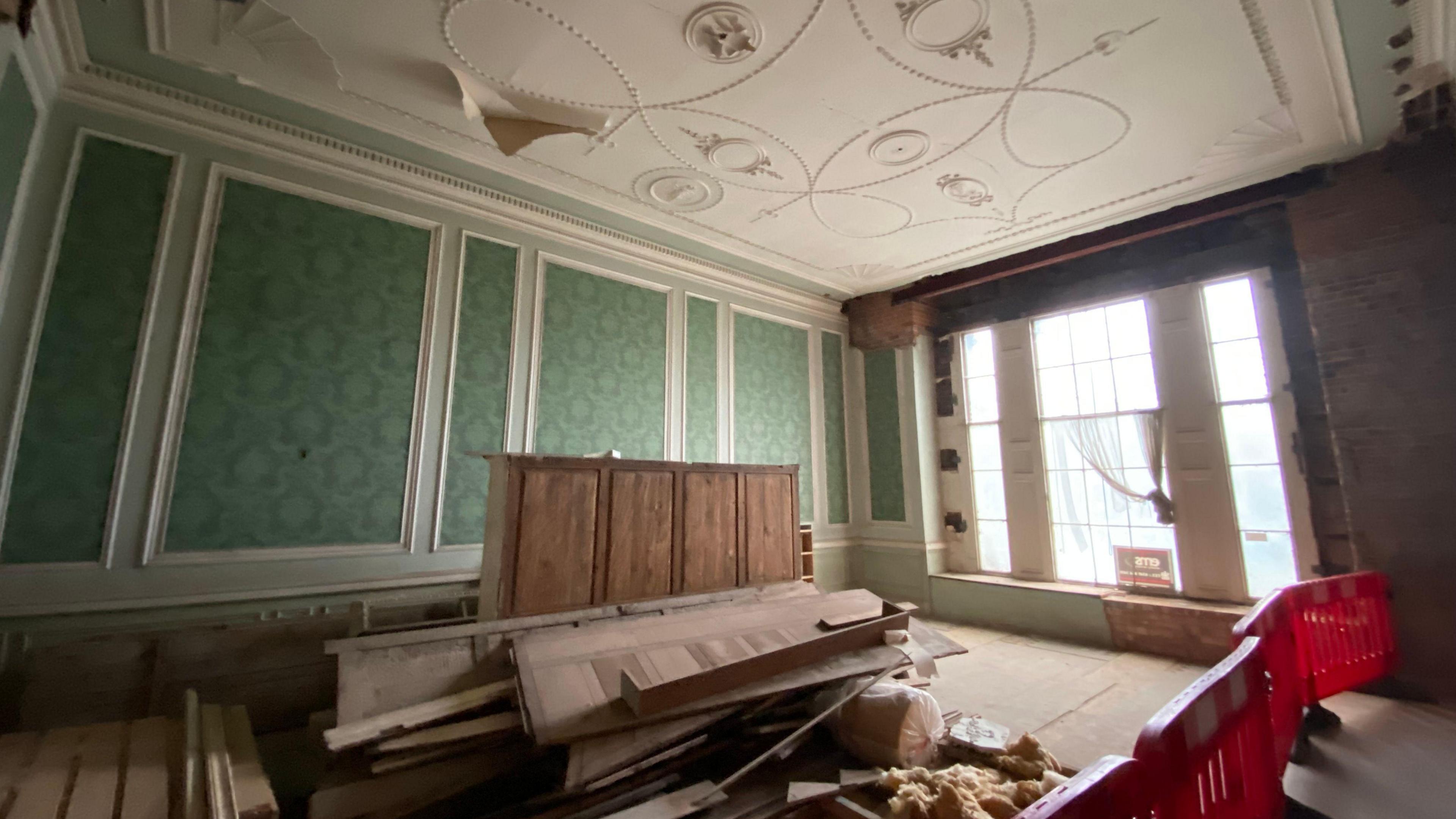 Inside Allestree Hall with building debris on the floor