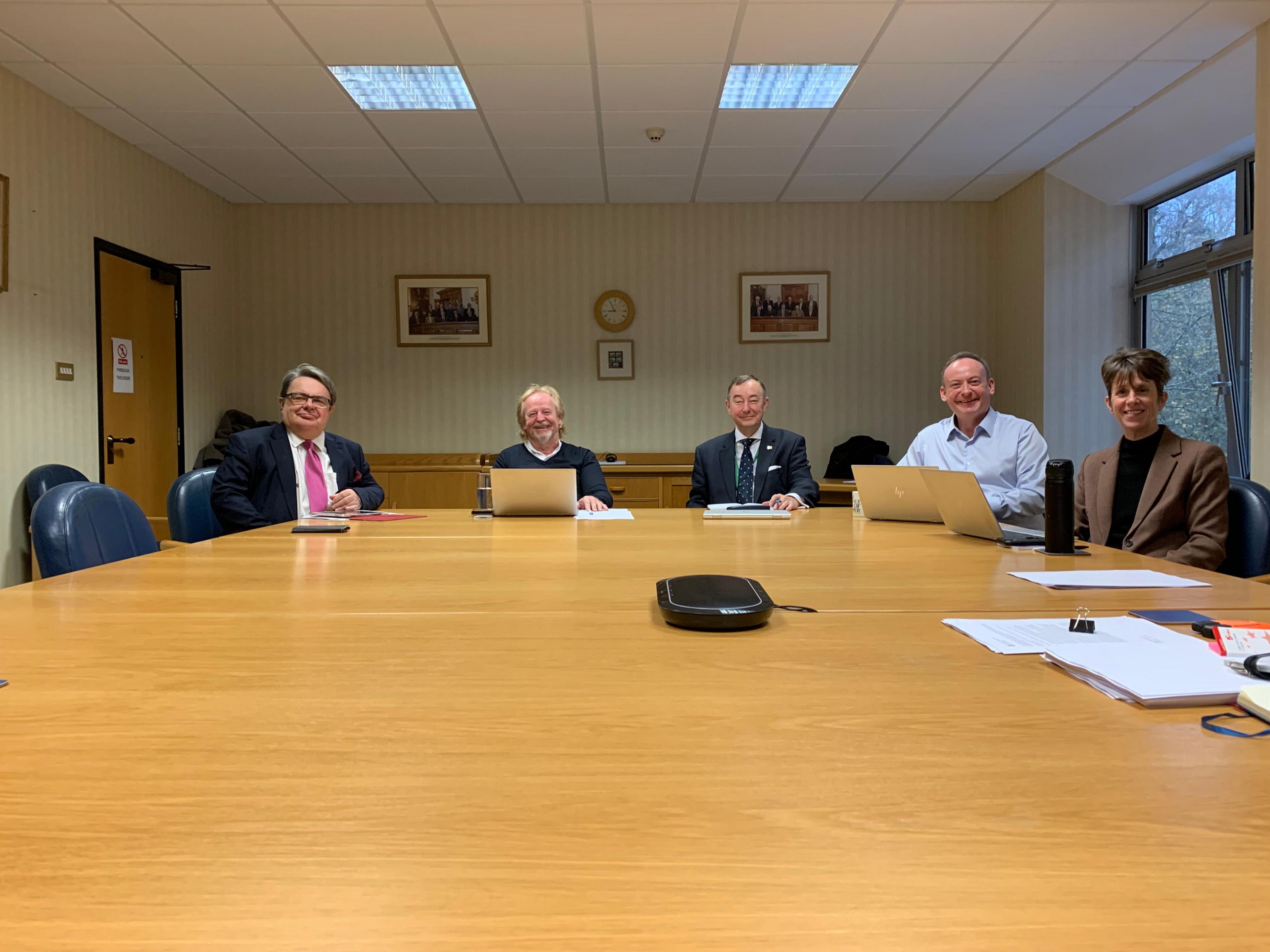 Politicians sat around a desk 