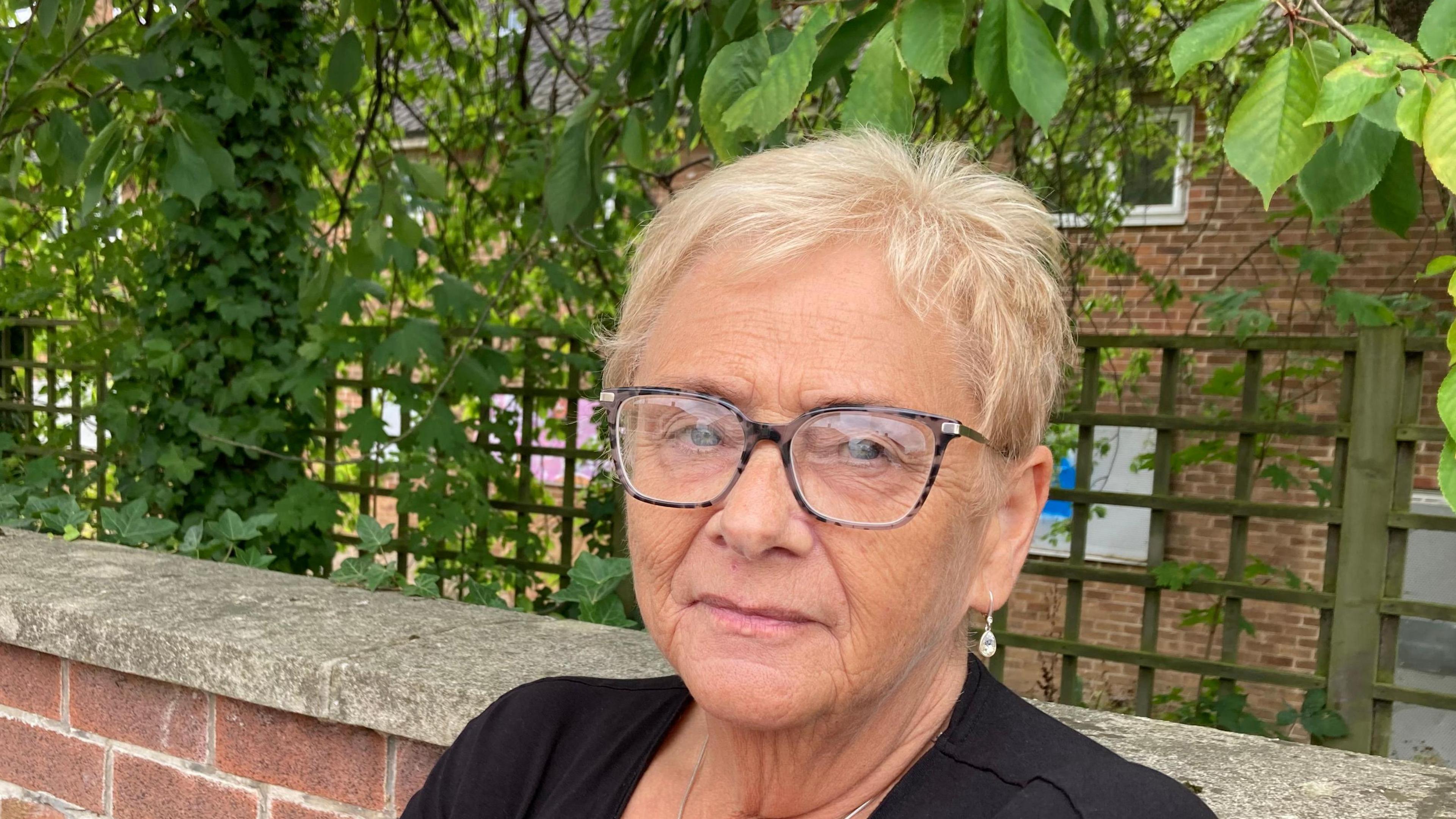 Sue Wilkinson stood in front of building