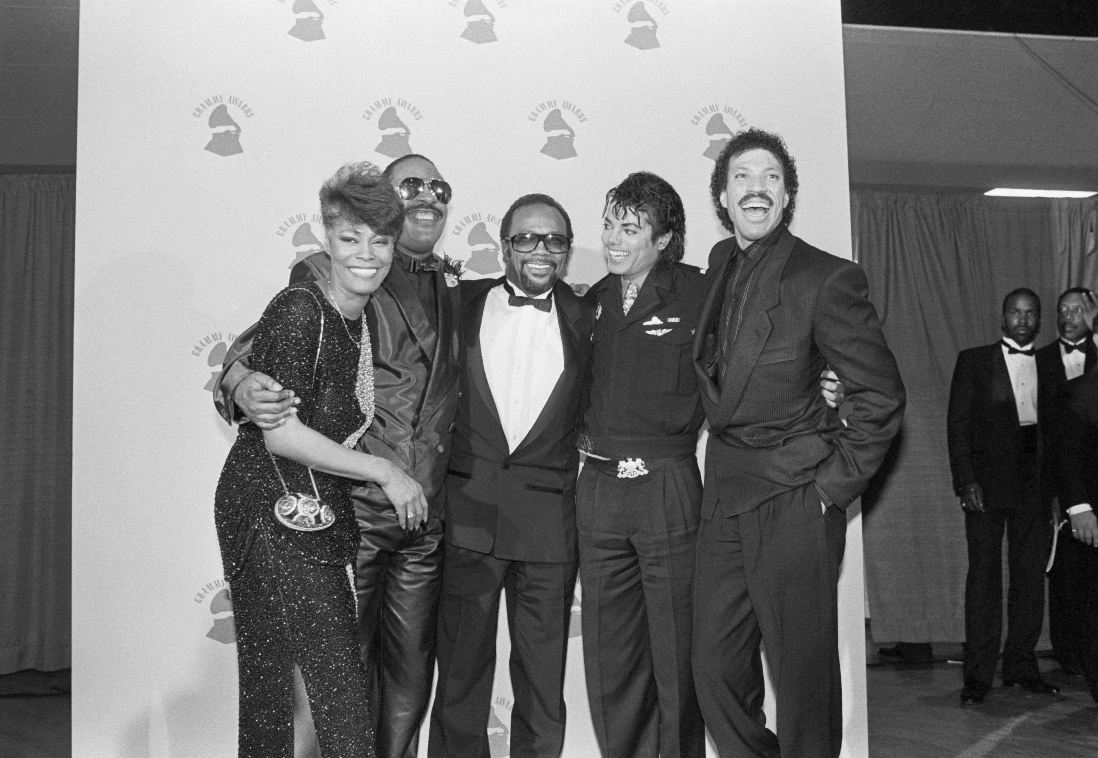 Dionne Warwick, Stevie Wonder, Quincy Jones, Michael Jackson, and Lionel Richie congratulate each other after We Are The World wins four Grammy Awards in 1986