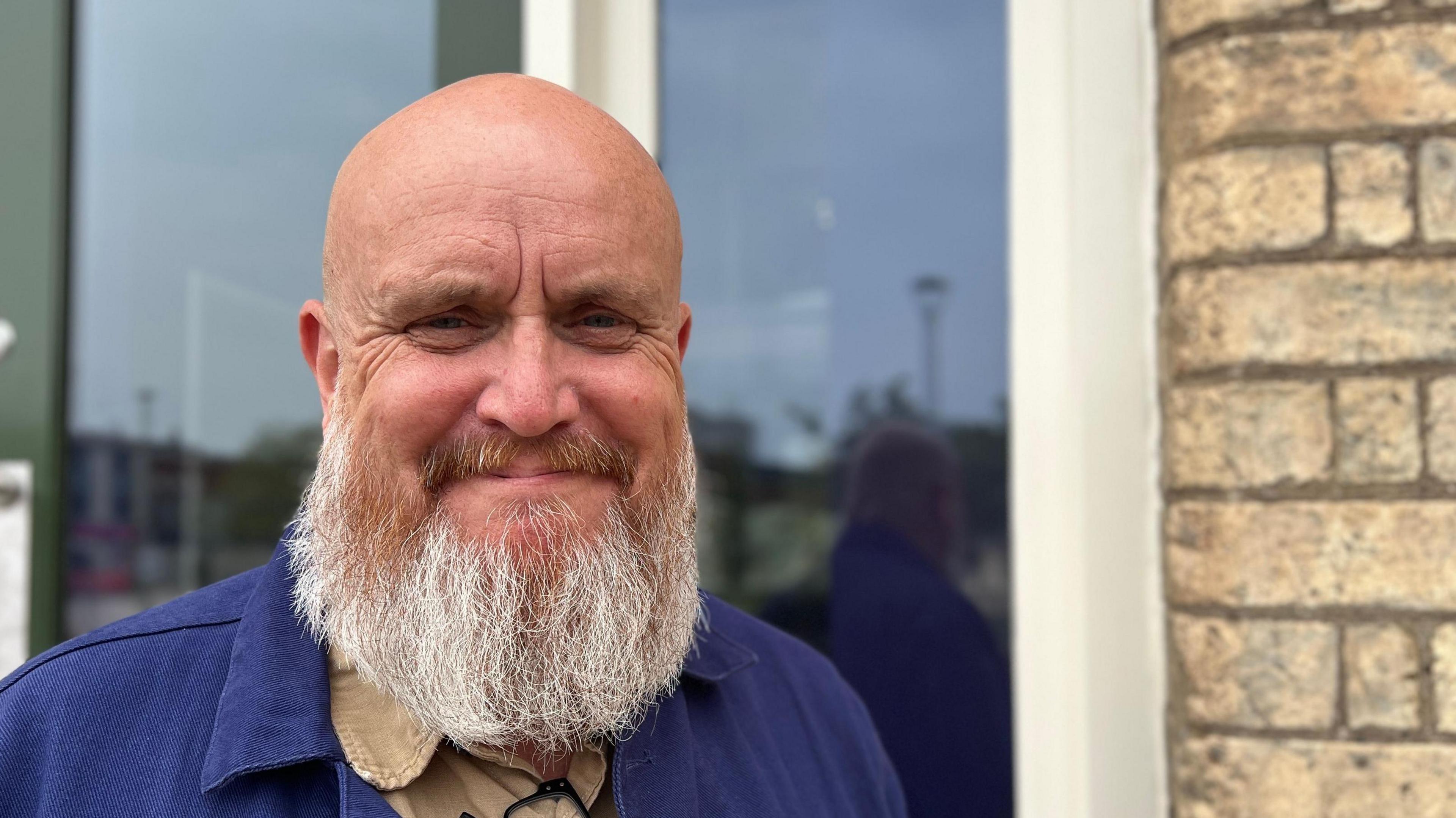Chief Executive JJ Tatten. He has a bald head and a grey beard.