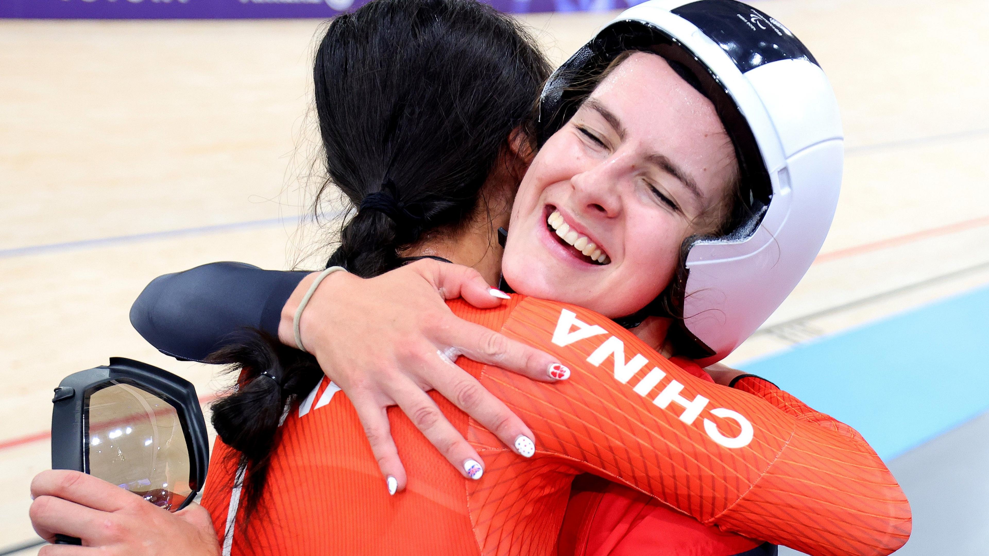 Daphne Schrager hugs a competitor