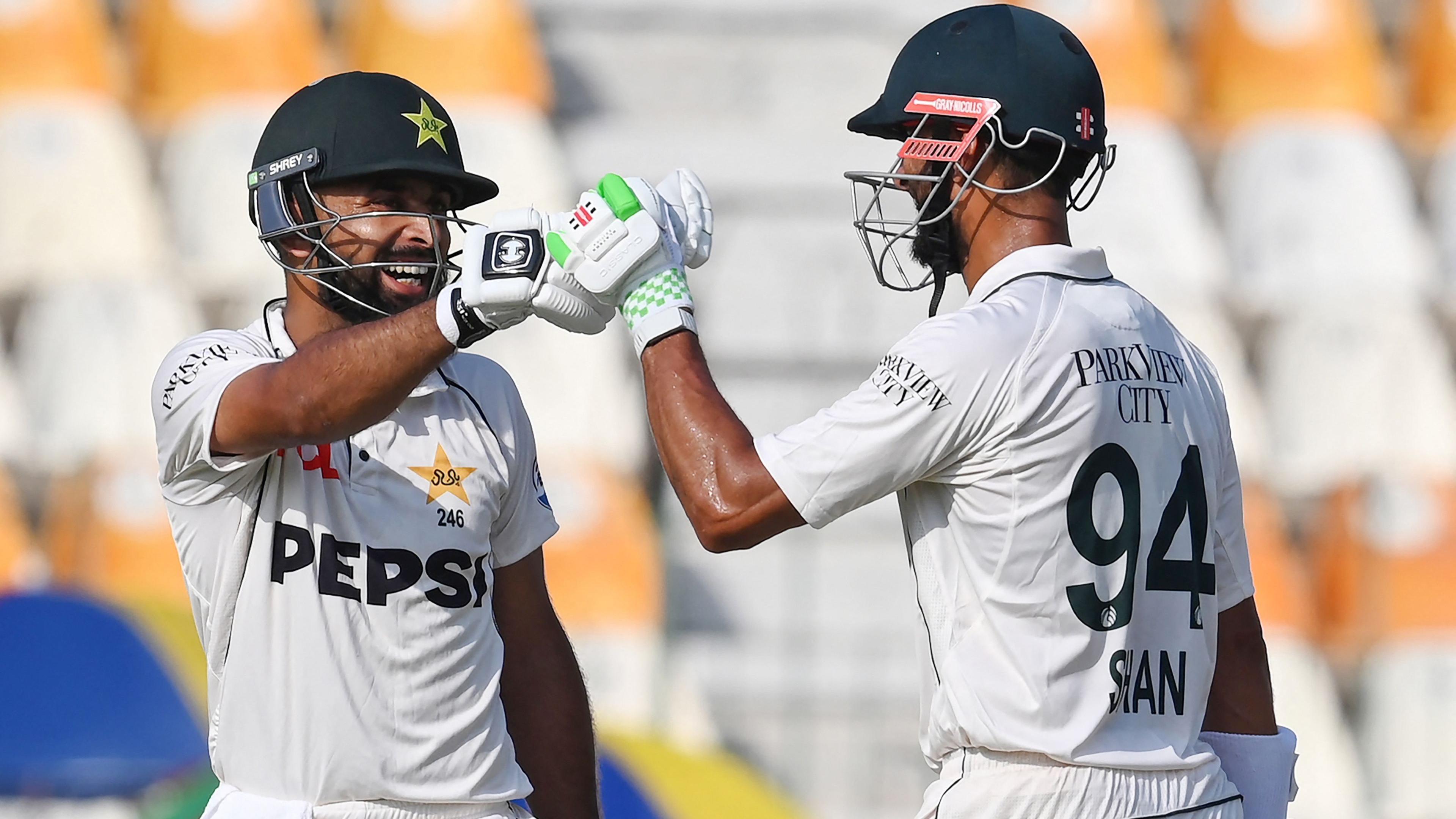 Pakistan's Abdullah Shafique celebrates with his captain Shan Masood after scoring a century during the first day of the first Test between Pakistan and England at the Multan Cricket Stadium